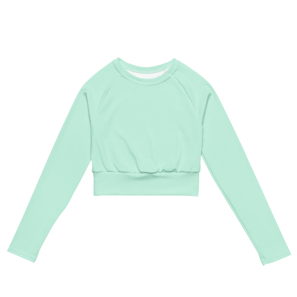 Women’s mint green long sleeve performance crop top with ribbed waistband and crew neckline made from breathable fabric