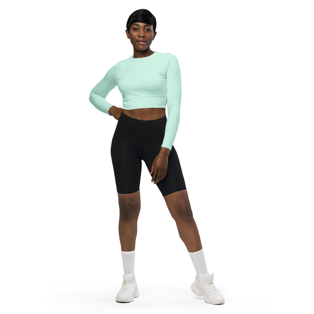 Women’s mint green long sleeve performance crop top made of breathable fabric for active wear