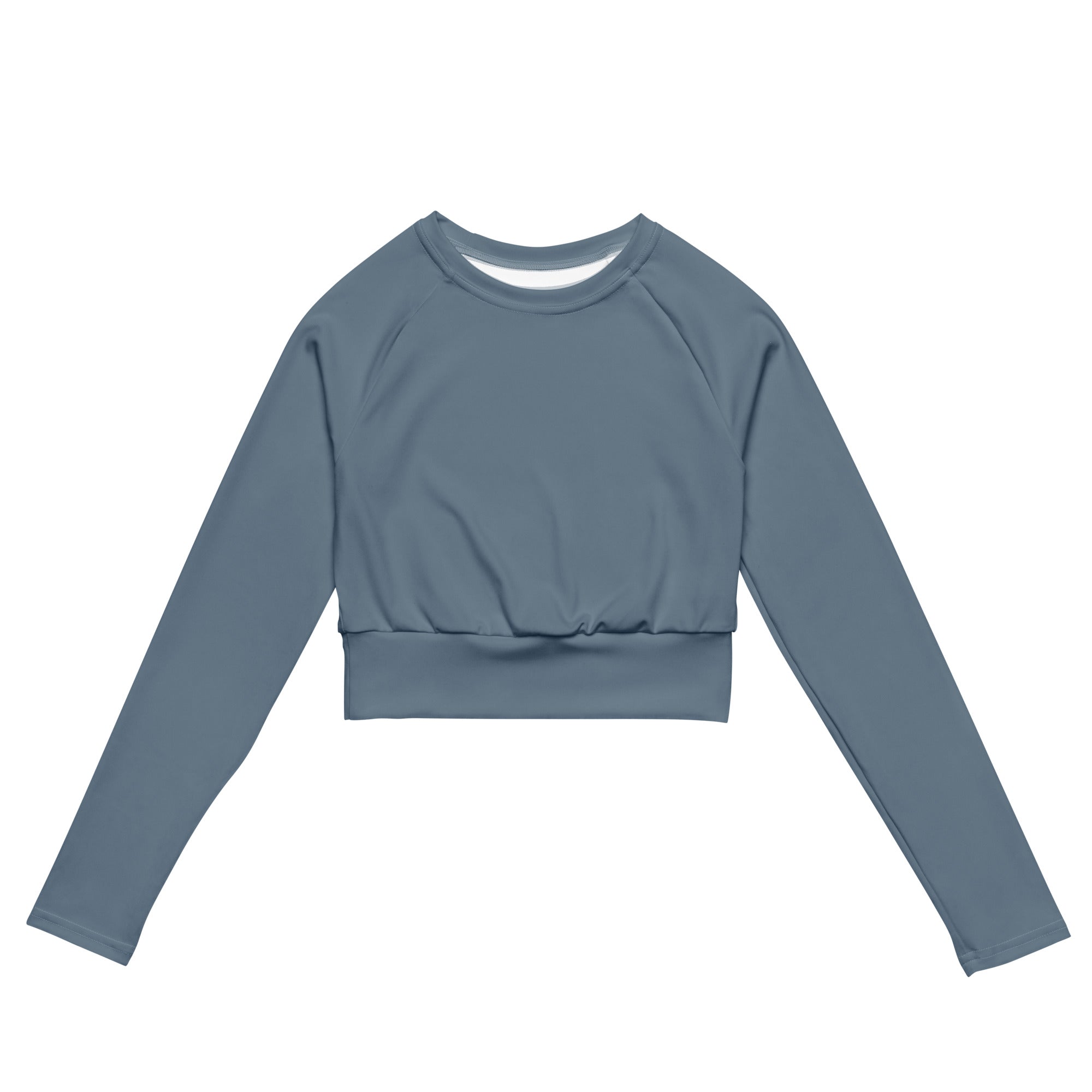 A women’s slate blue long sleeve performance crop top with ribbed waistband and subtle seam detailing