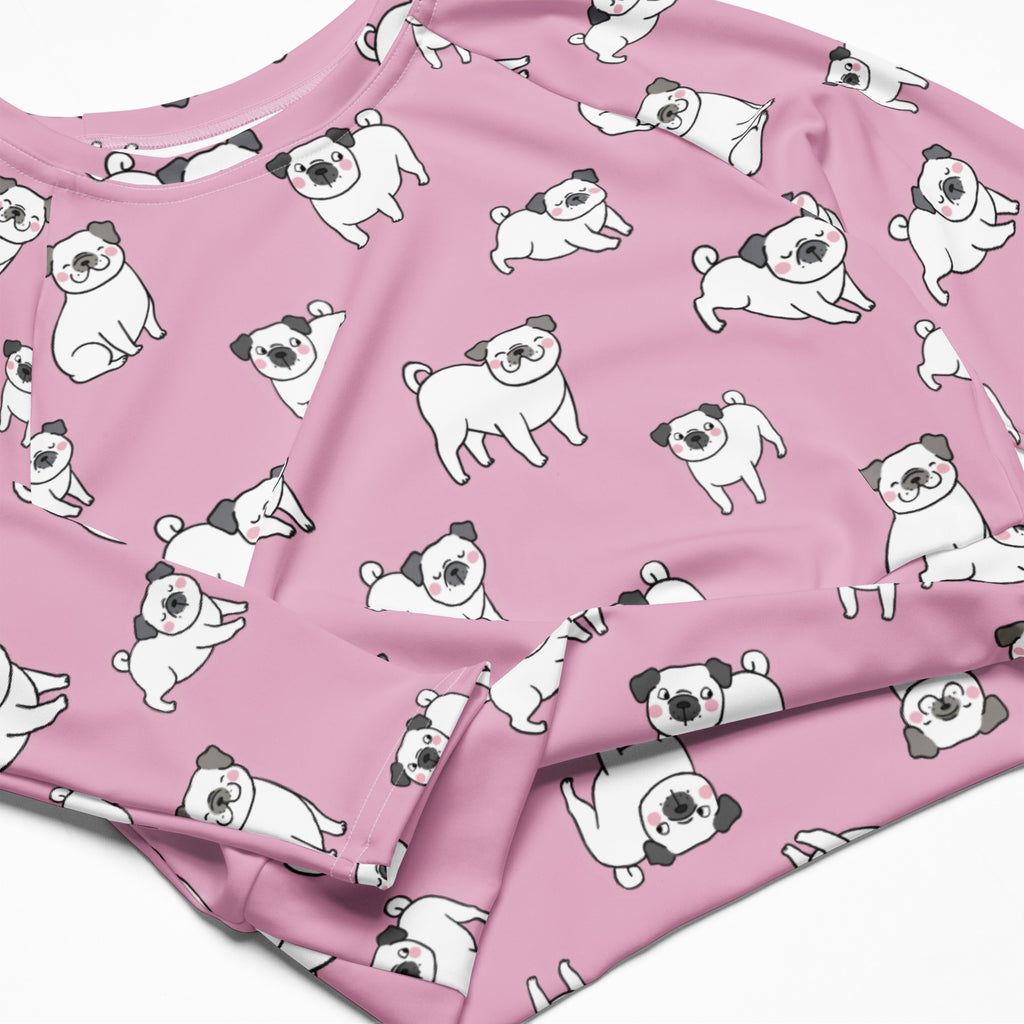 Women’s pink long sleeve performance crop top with white and black cartoon pug pattern on soft fabric