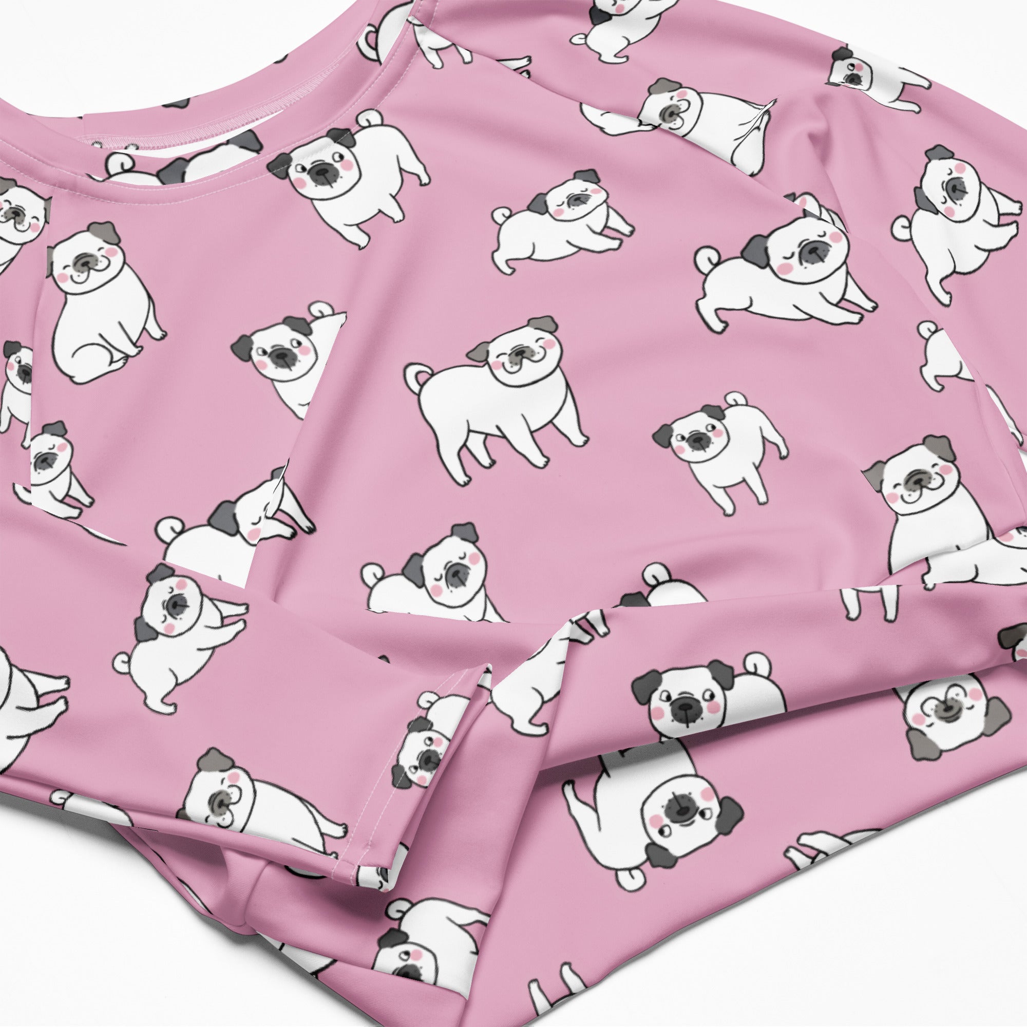 Women’s pink long sleeve performance crop top with white and black cartoon pug pattern on soft fabric