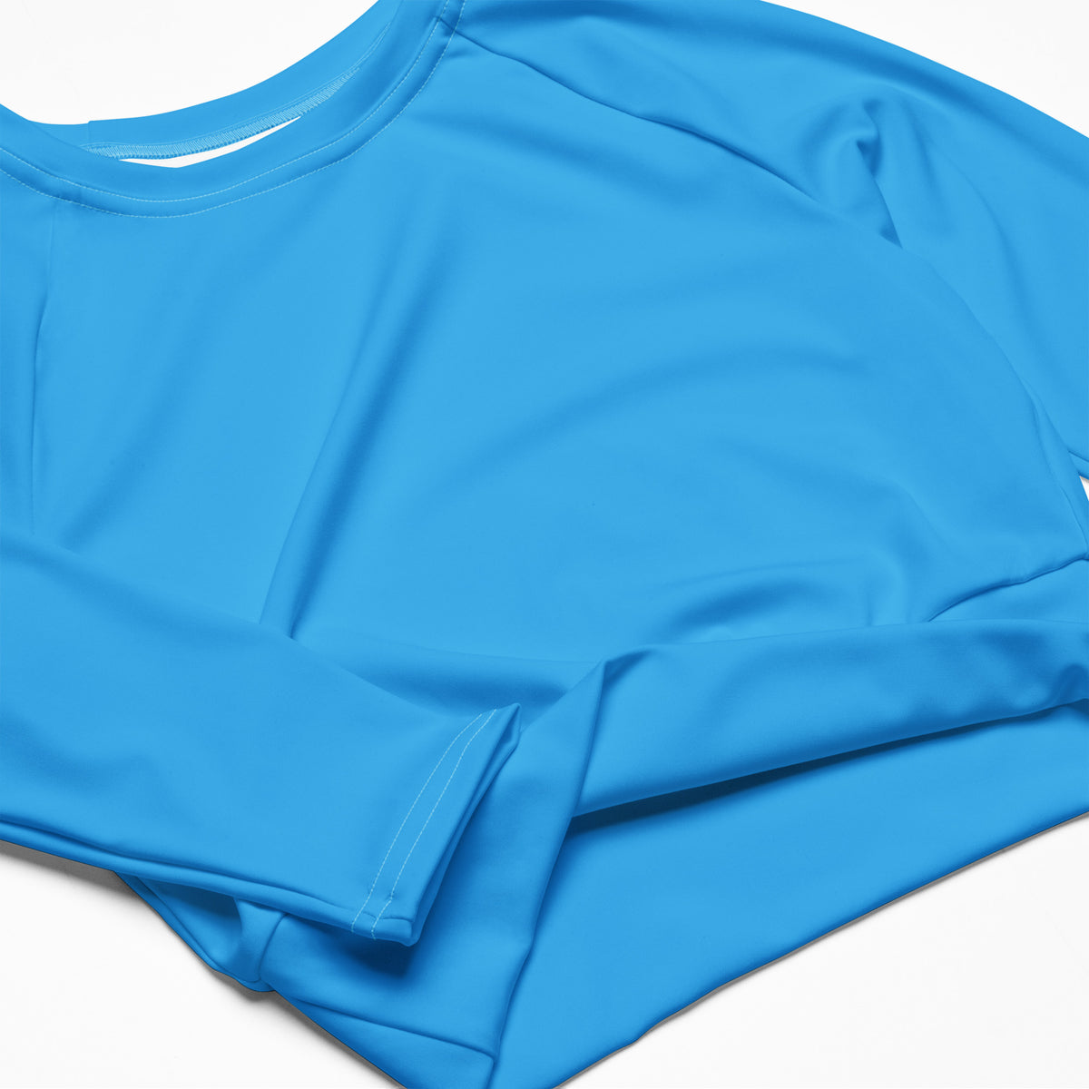 Women’s sky blue long sleeve performance crop top with smooth stretchy fabric and rounded neckline