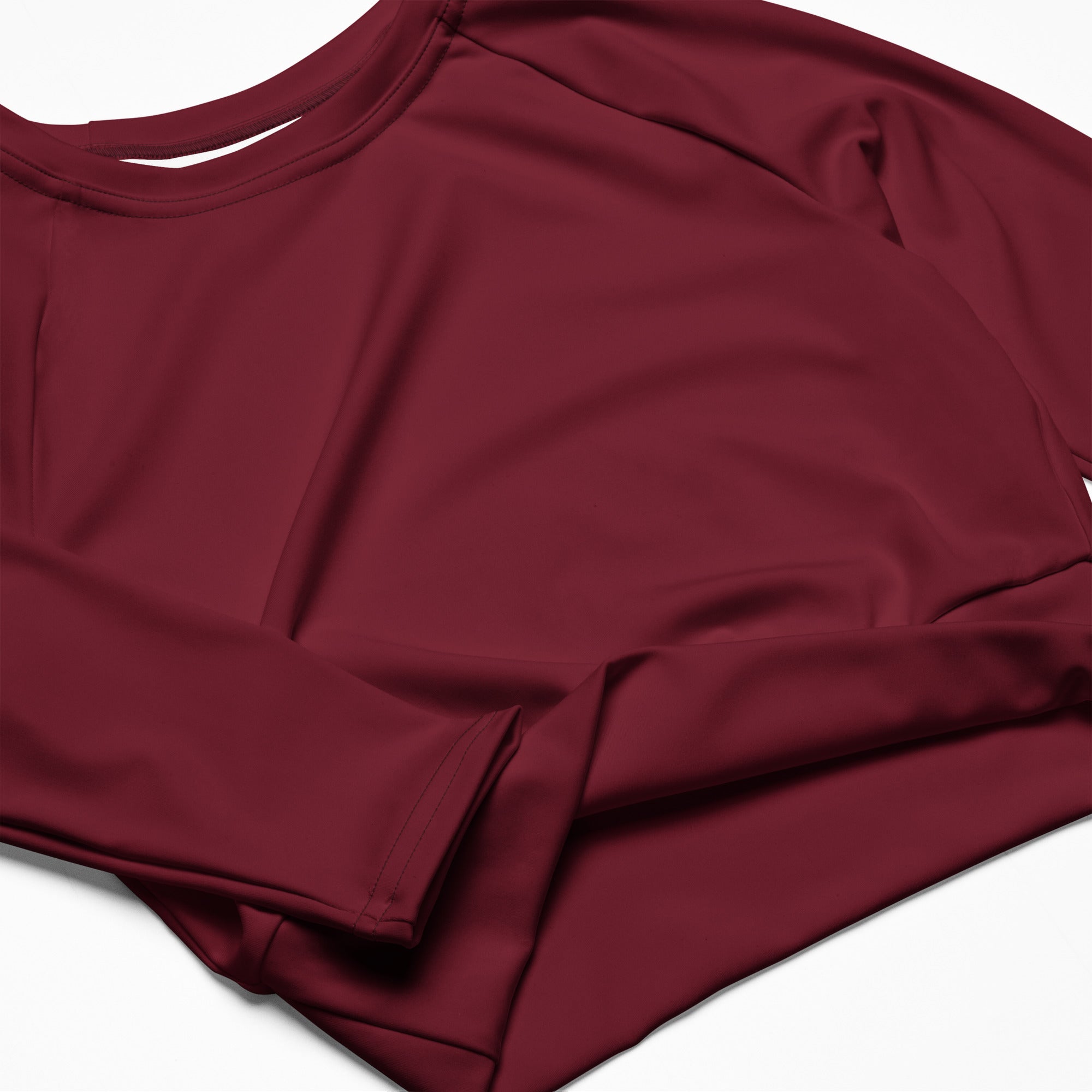 Women’s maroon long sleeve performance crop top with soft smooth fabric and rounded neckline