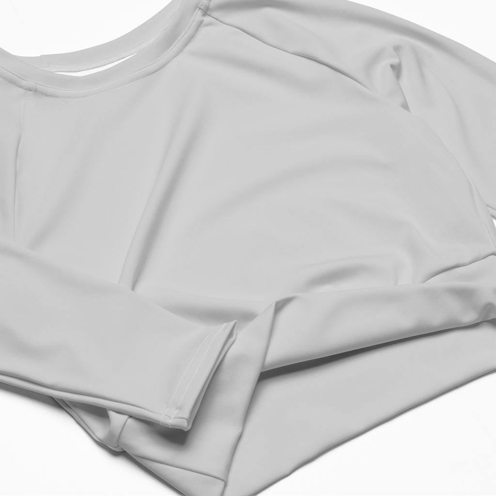 Women’s light gray long sleeve performance crop top with a soft smooth fabric and simple round neckline