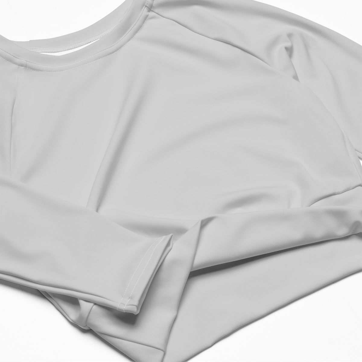 Women’s light gray long sleeve performance crop top with a soft smooth fabric and simple round neckline