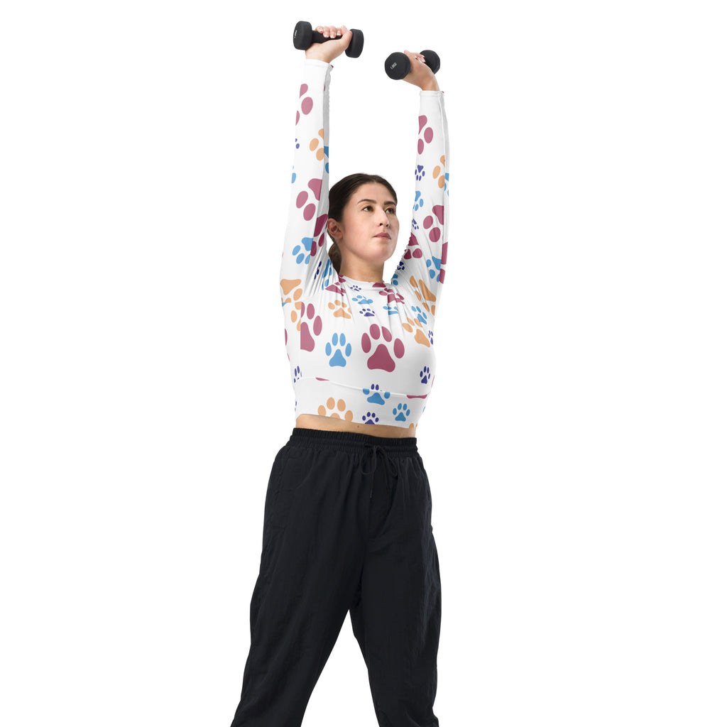 White long sleeve crop top with colorful pink blue and brown paw print pattern for women performance wear