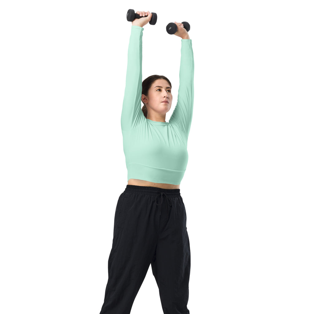 Black dumbbells with textured grips and smooth rounded ends for women’s mint green long sleeve performance crop top workouts