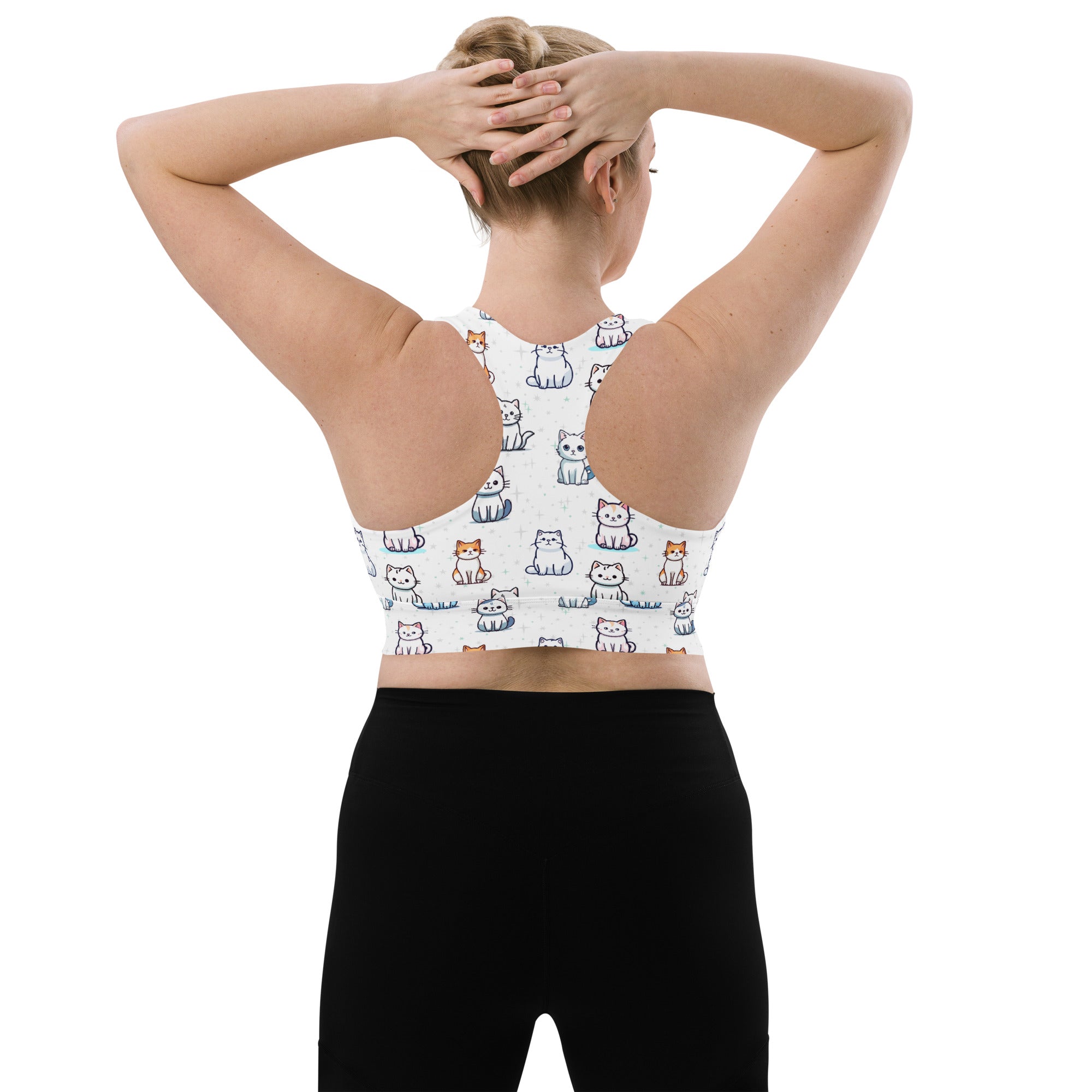 White longline sports bra with playful multicolor cartoon cats, buttery soft recycled fabric, racerback design, high support