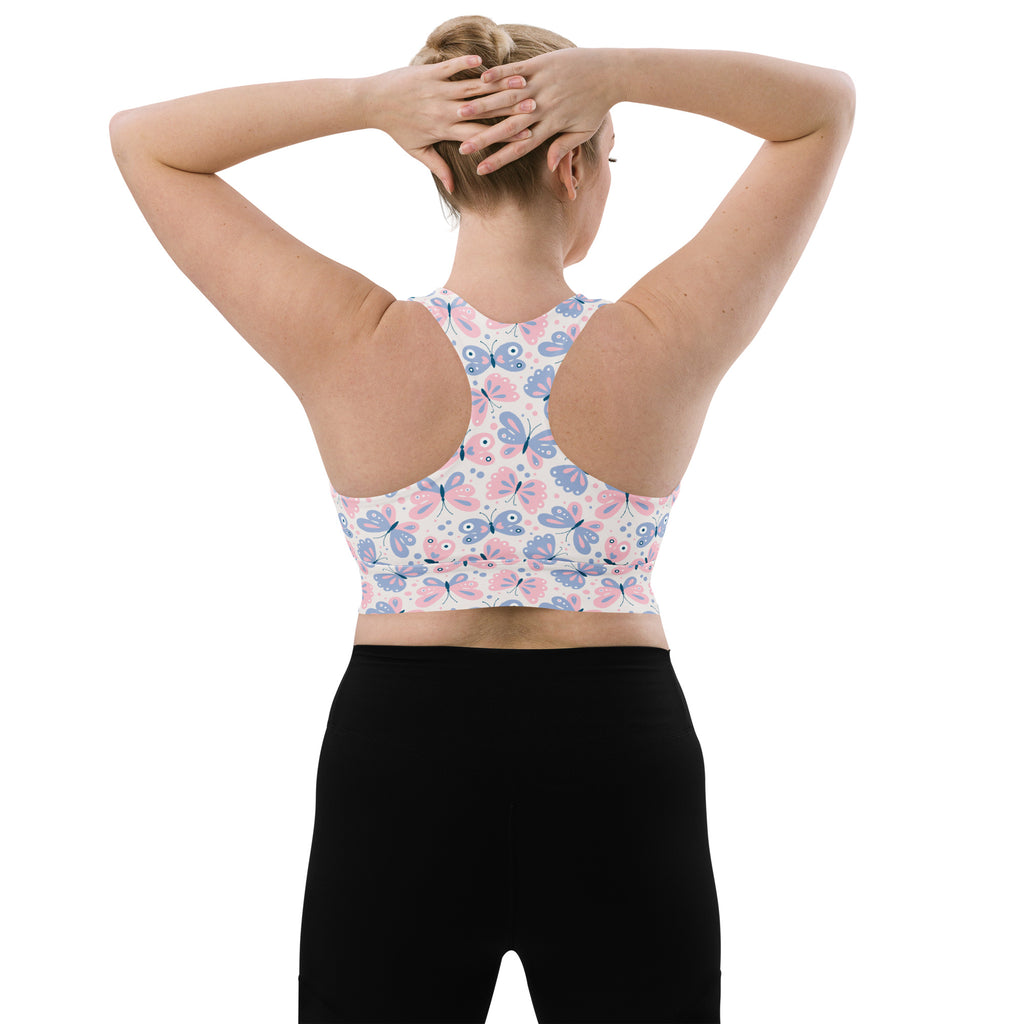 Women’s butterfly print buttery soft recycled longline sports bra with pink and blue pattern on white base for high intensity support