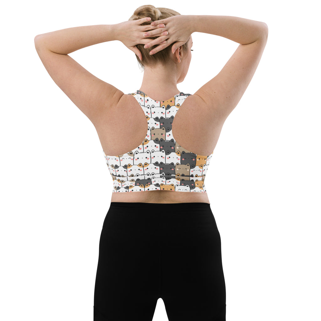 Women’s white longline sports bra with playful cartoon cat pattern offers high intensity support and quick dry fabric