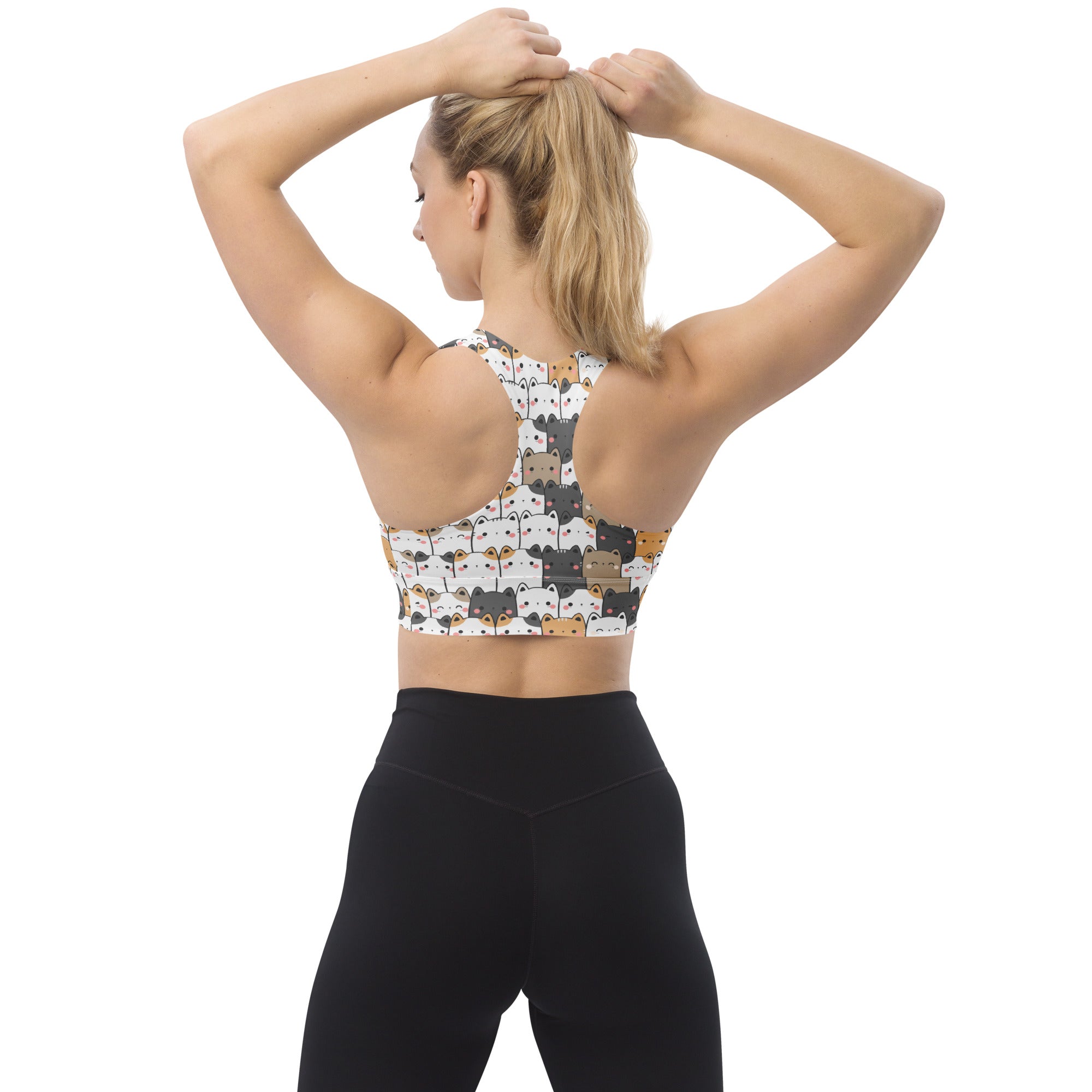 White longline sports bra with kawaii black gray and orange cartoon cat faces made from buttery soft recycled fabric