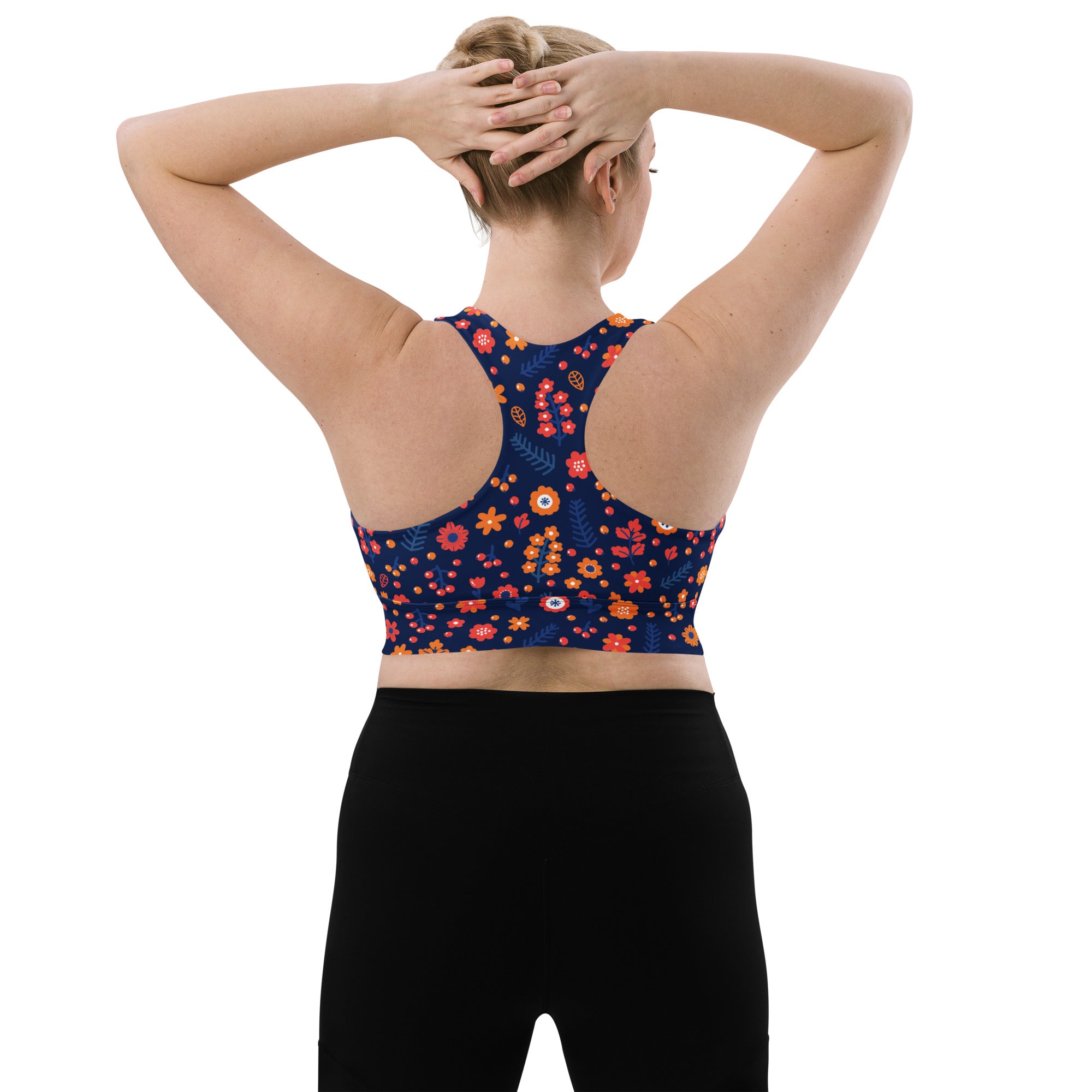 Women’s navy blue longline sports bra with vibrant orange floral pattern buttery soft recycled fabric high intensity support