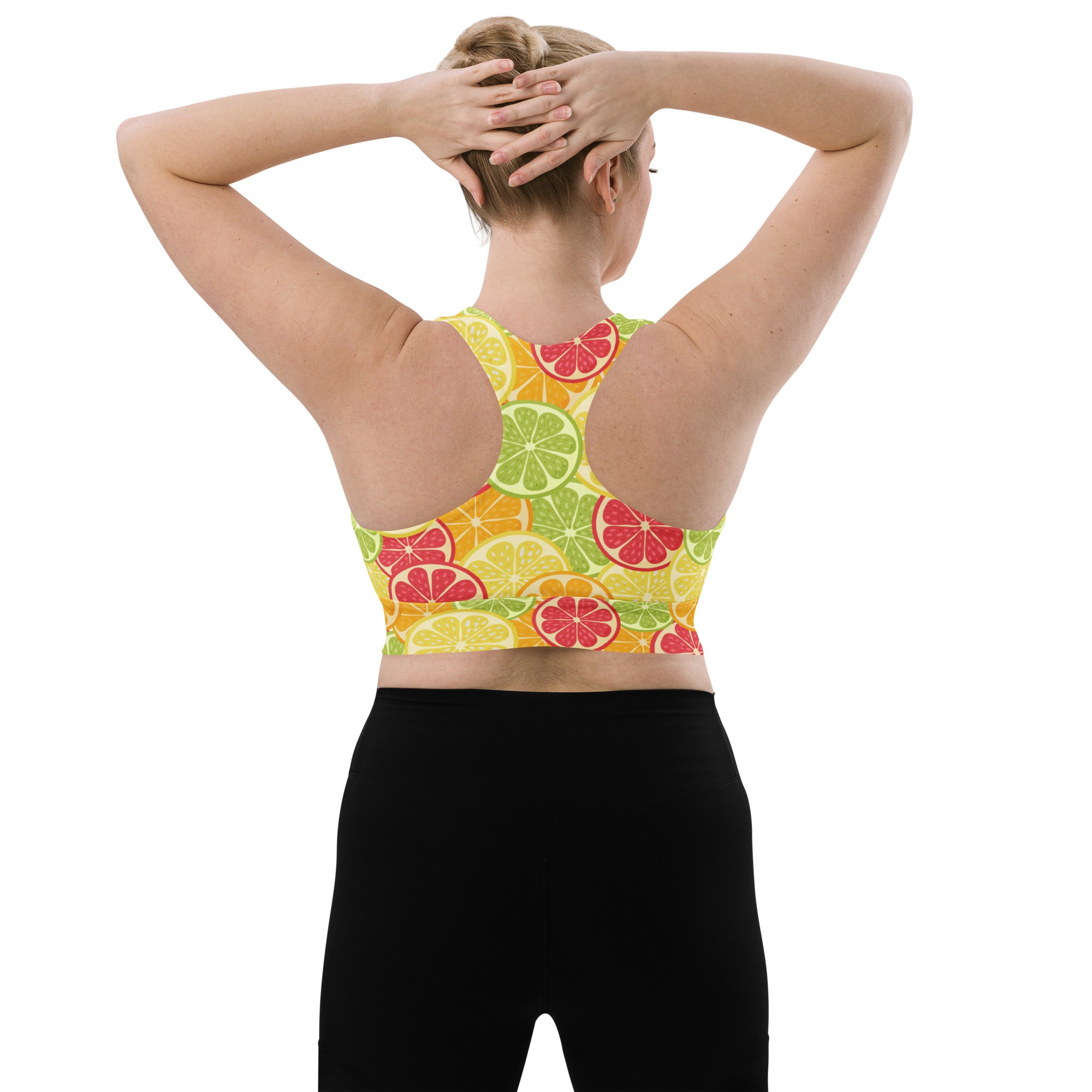 Women’s citrus slice buttery soft recycled longline sports bra with vibrant yellow green and red citrus pattern