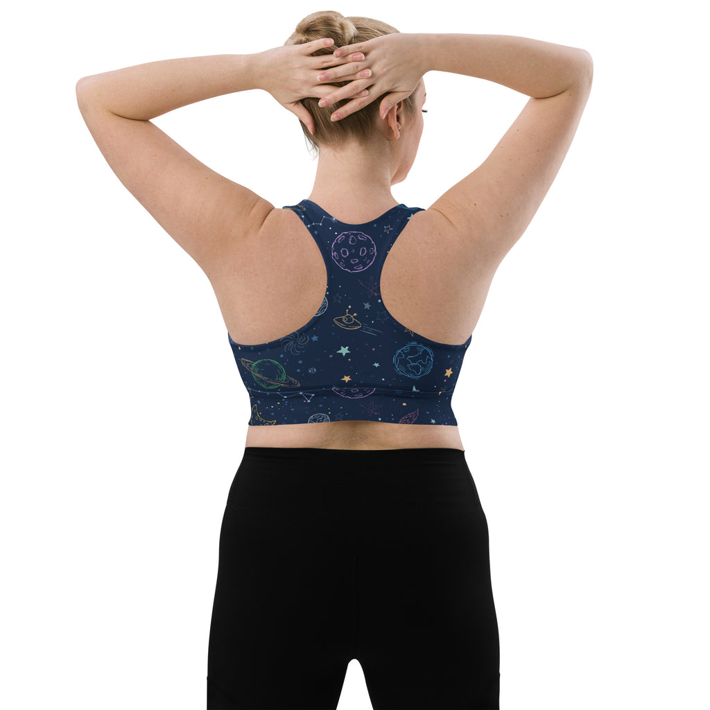 A navy blue women’s longline sports bra with a colorful cosmic design made from buttery soft recycled fabric