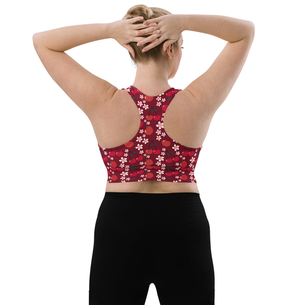 A red deep cherry blossom sports bra with floral cherry pattern racerback made from buttery soft recycled fabric