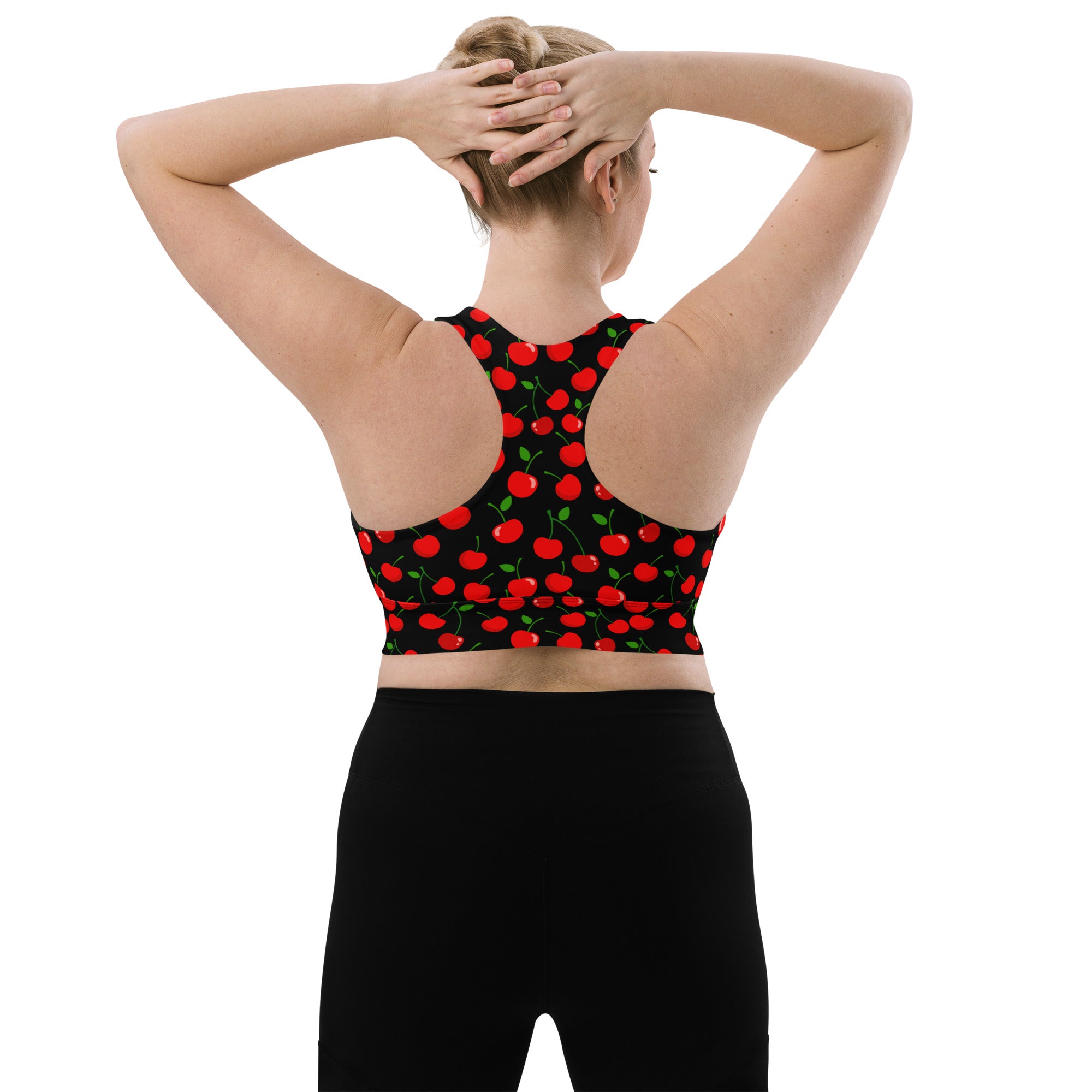 Women’s black longline sports bra with vibrant red cherry pattern green stems buttery soft recycled fabric high support