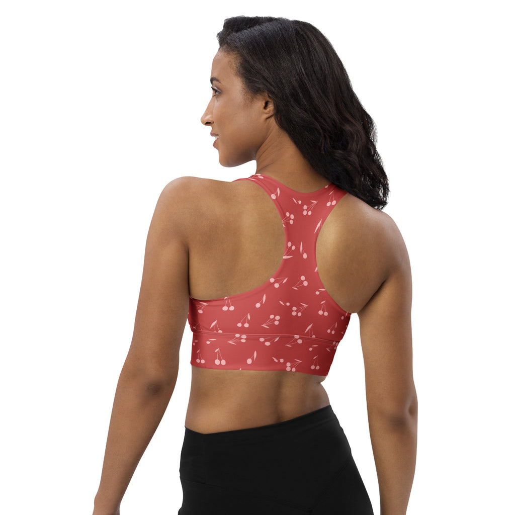 Women’s soft red cherry longline sports bra with buttery soft recycled fabric, high intensity support, and removable padding