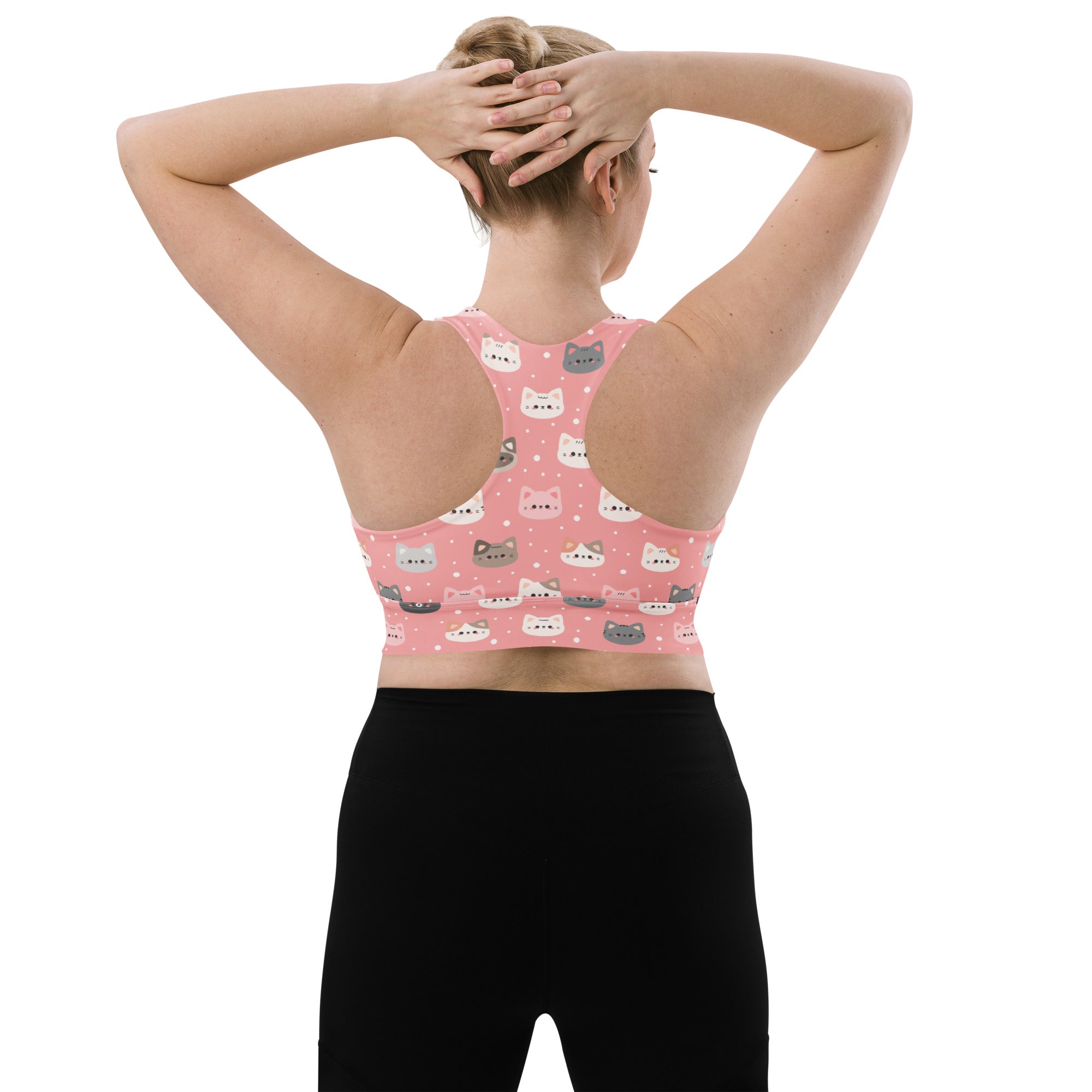 Pink longline sports bra with playful white gray and light blue cartoon cats made from buttery soft recycled fabric