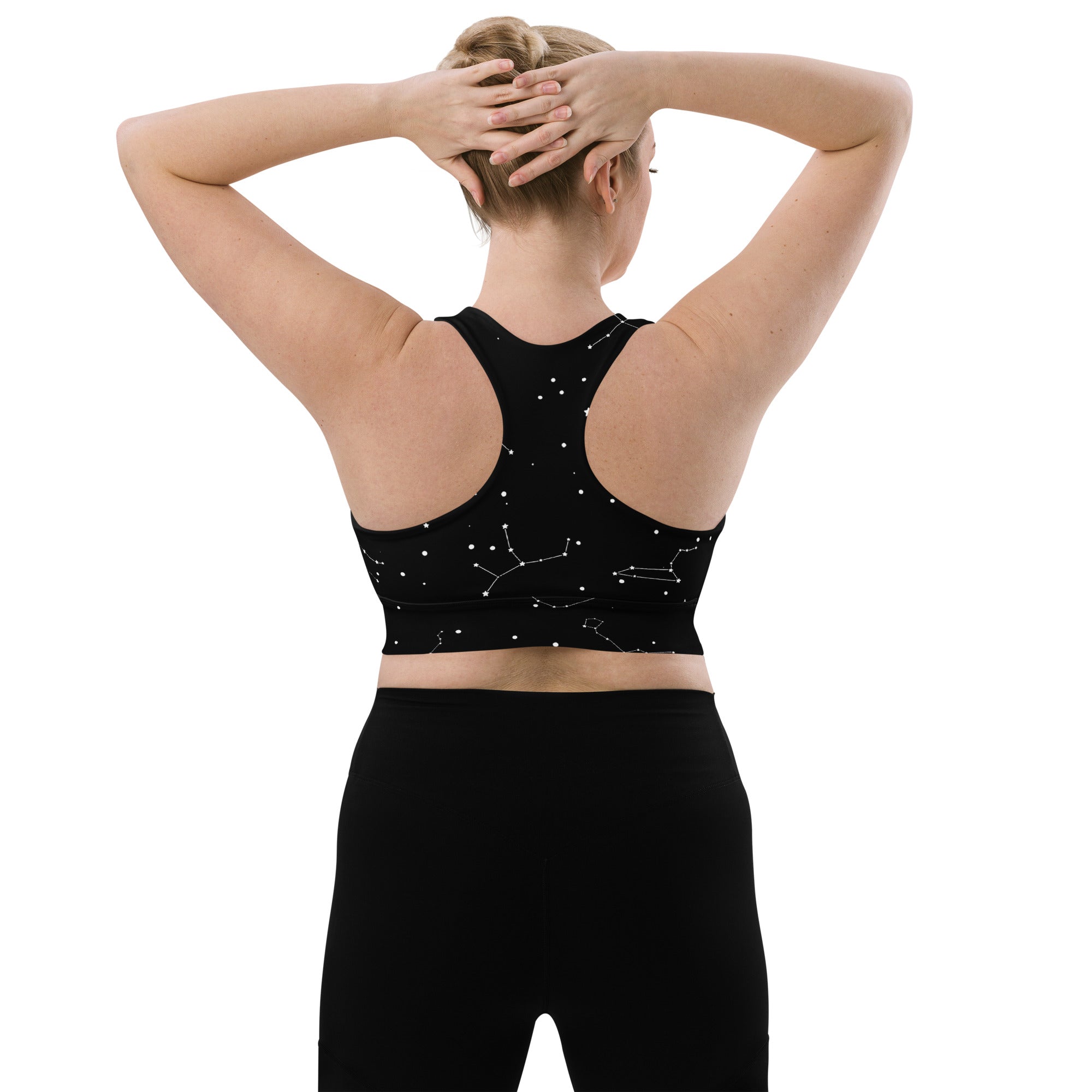 Women’s longline black sports bra with white constellation print made from recycled fabric for high intensity support