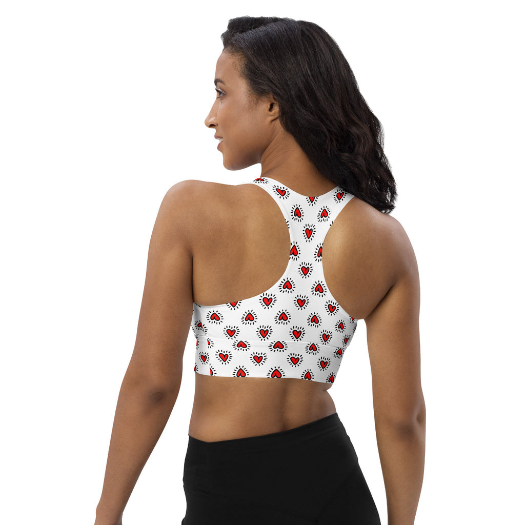 White longline sports bra with red doodle heart patterns made from buttery soft recycled fabric for high intensity support
