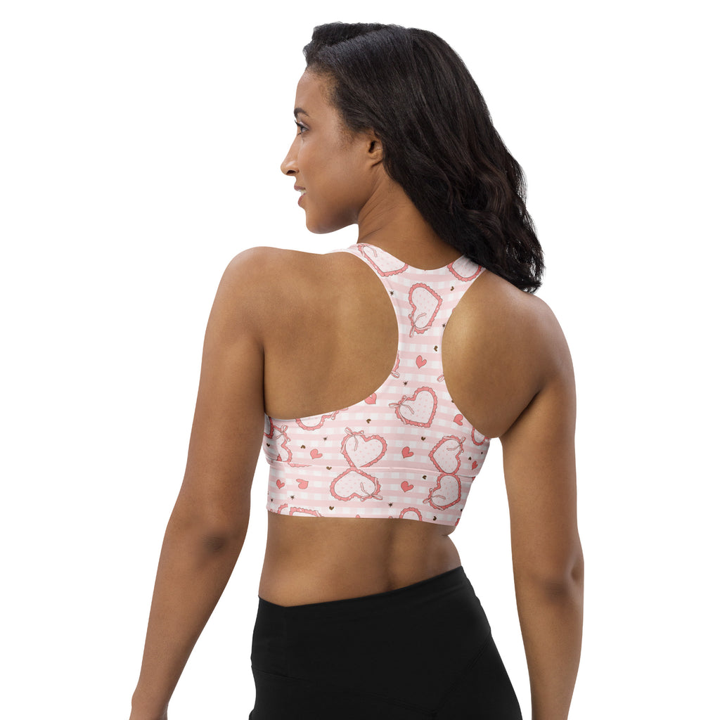 Women’s pink gingham heart sports bra with thin straps and racerback design made from buttery soft recycled fabric