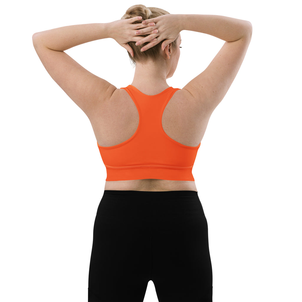 Women’s buttery soft orange recycled sports bra with seamless construction racerback design and high intensity support