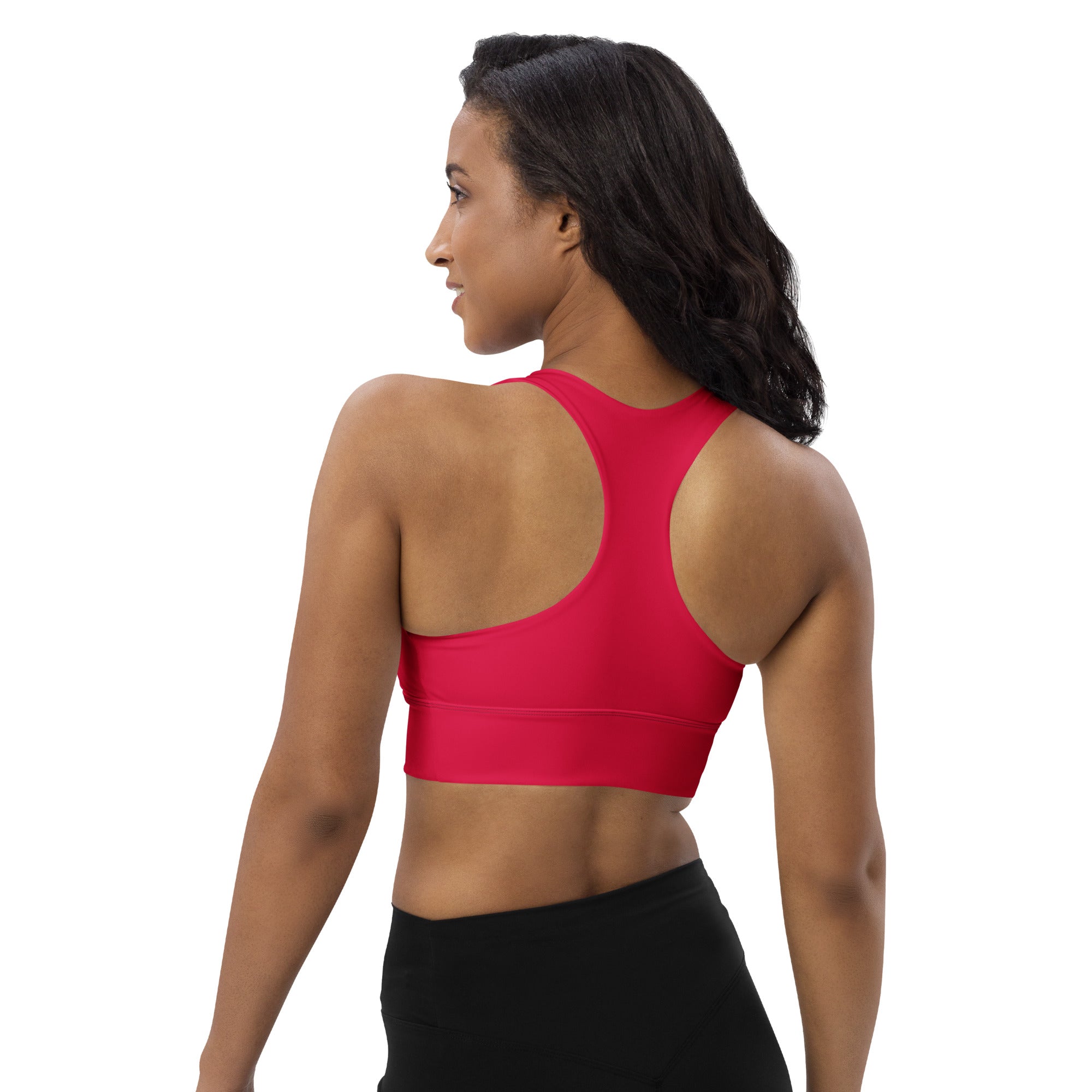Woman wearing a vibrant red longline sports bra with racerback seamless stretchy fabric for high intensity support