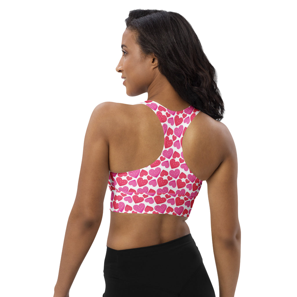 Women’s pink and white heart-patterned longline sports bra with racerback design high intensity support and quick dry