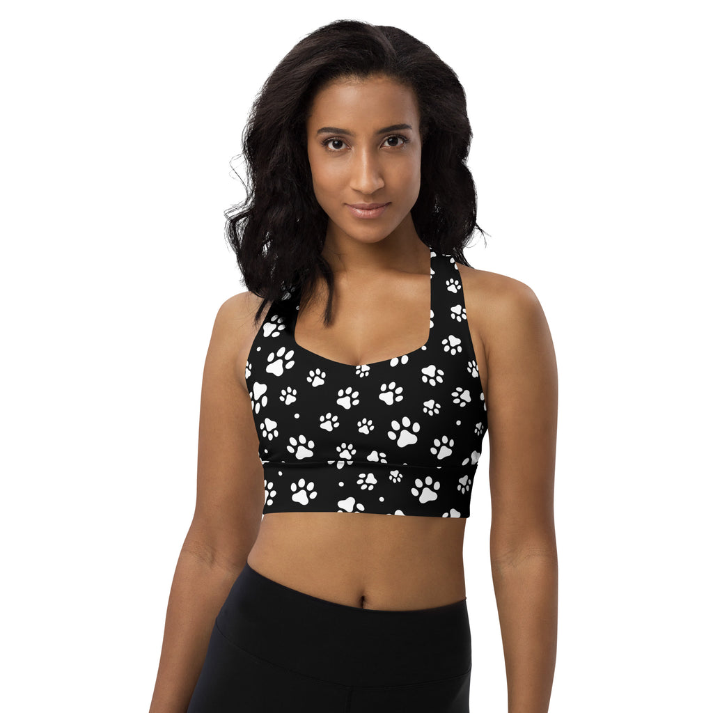 Women’s black recycled longline sports bra with white paw print pattern high intensity support and quick dry fabric