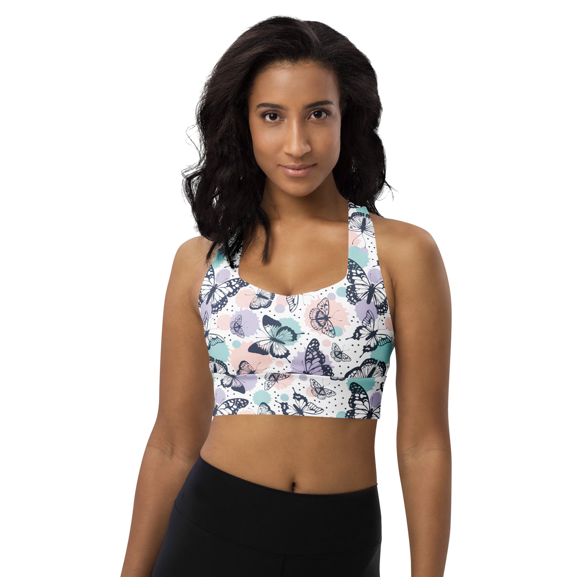 White longline sports bra with black teal and lavender butterfly pattern buttery soft recycled fabric high intensity support