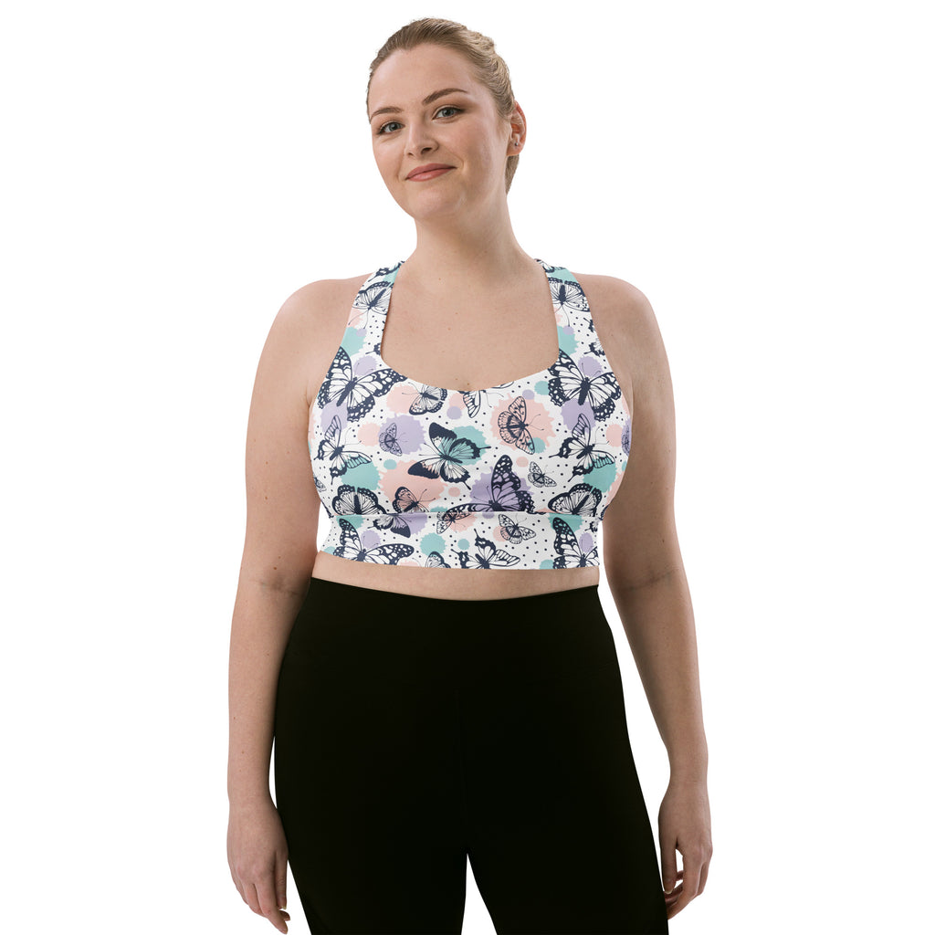 Women’s plus-size white sports bra with pastel butterfly print made from buttery soft recycled fabric for high intensity support