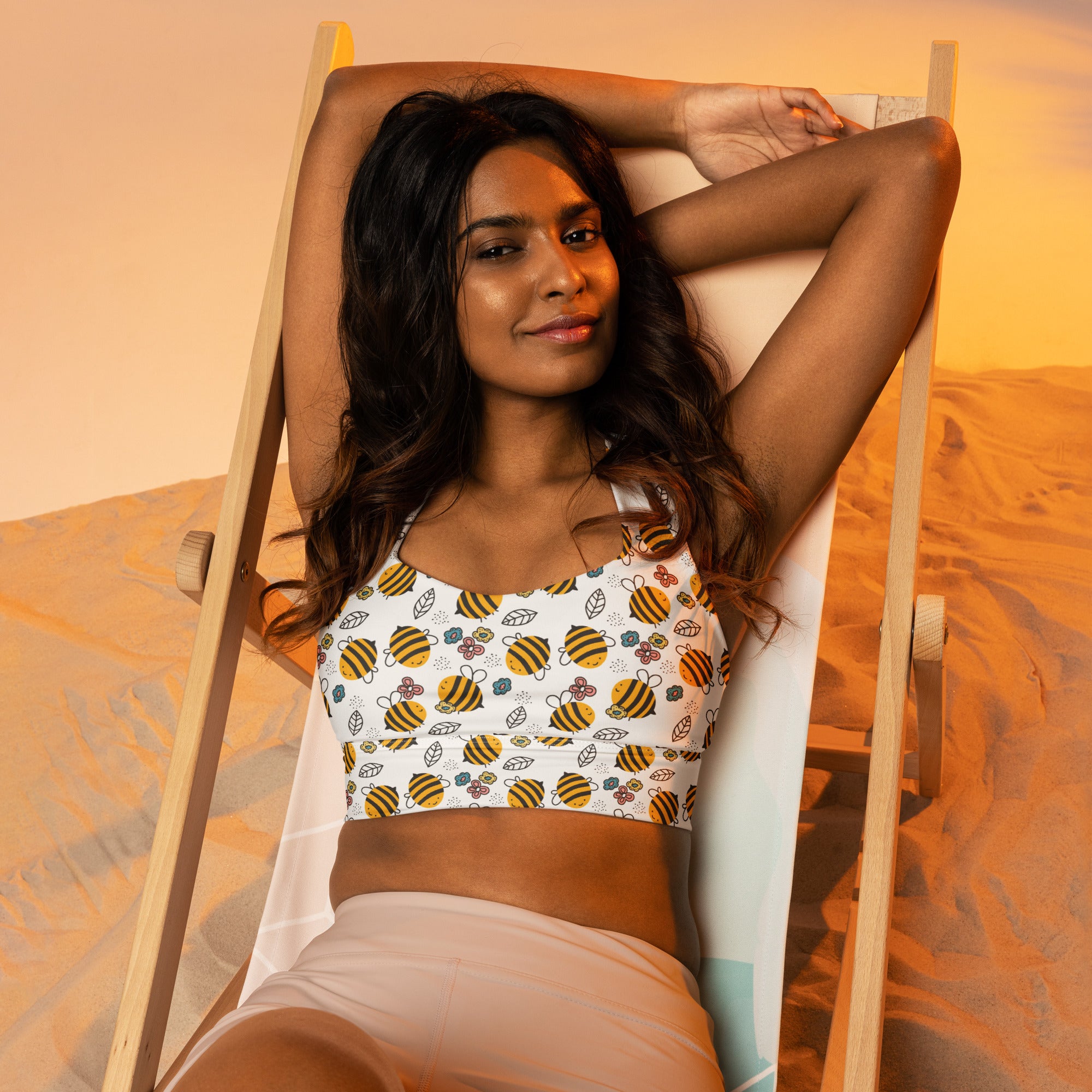 Women’s longline sports bra with white fabric, yellow and black bumblebee pattern, buttery soft recycled material, high support