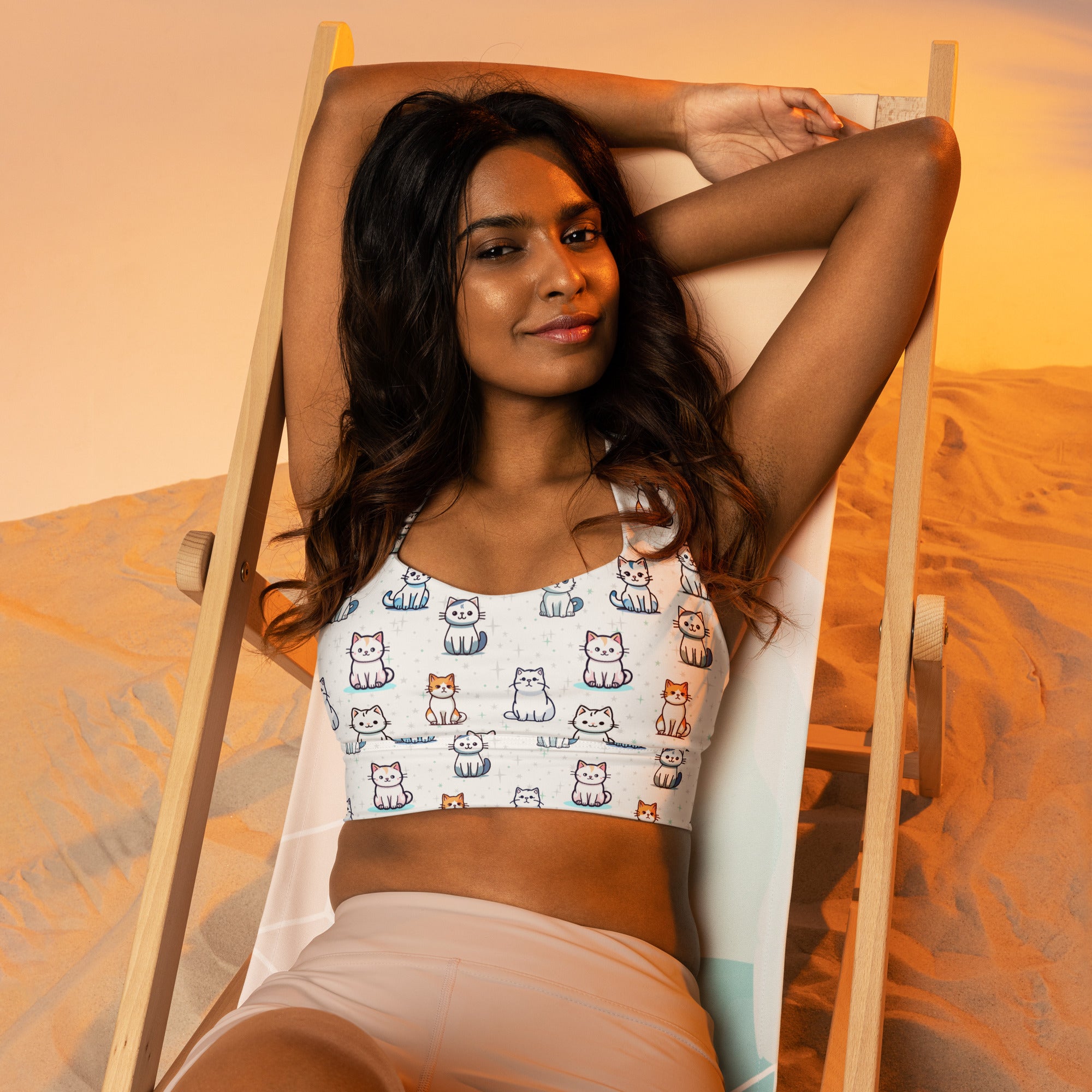 White buttery soft recycled longline sports bra with playful blue gray and orange cartoon cat print for high intensity support