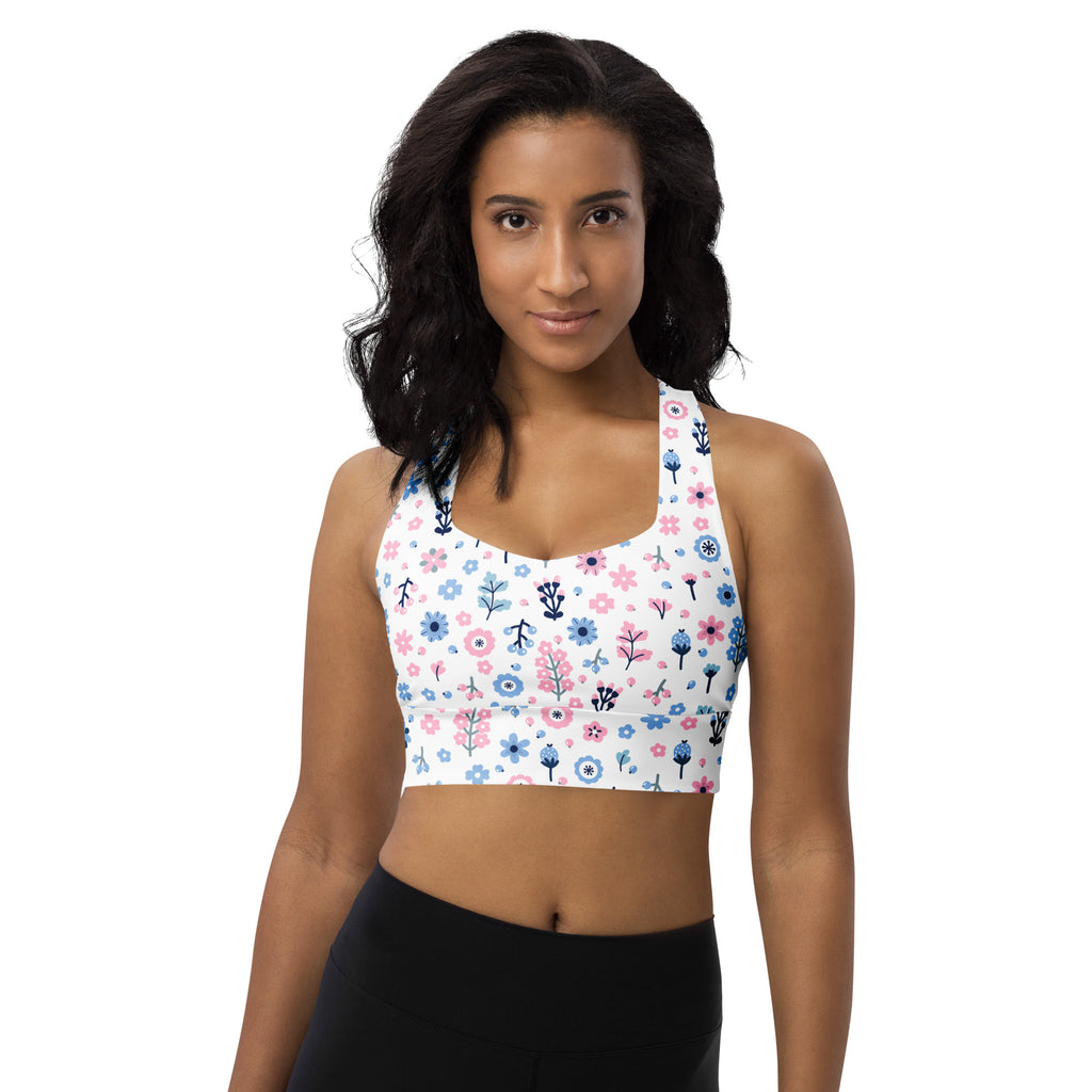 White longline sports bra with pink and blue floral print black outlines buttery soft recycled fabric high intensity support