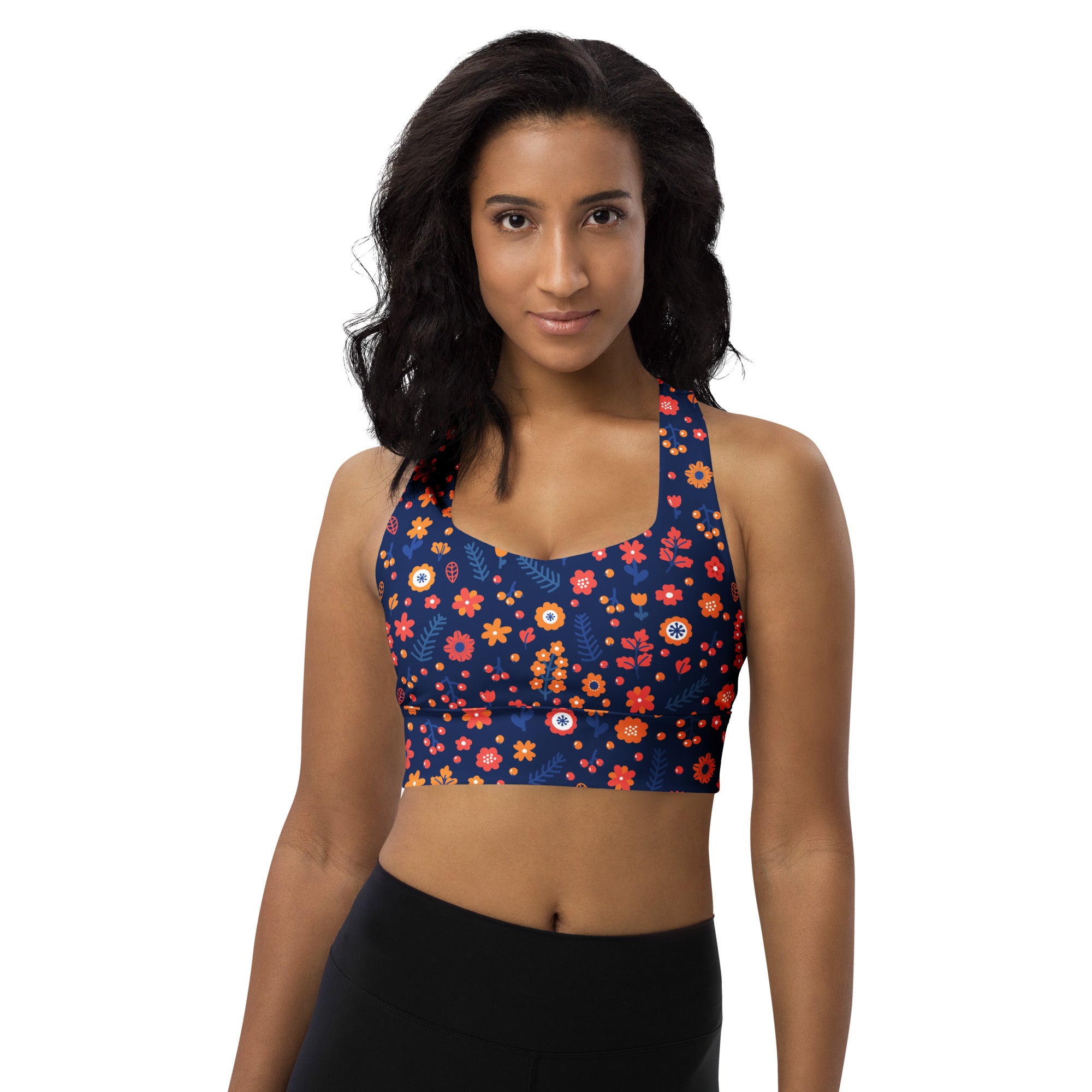 A navy blue longline sports bra with vibrant orange pink red floral pattern made from buttery soft recycled fabric
