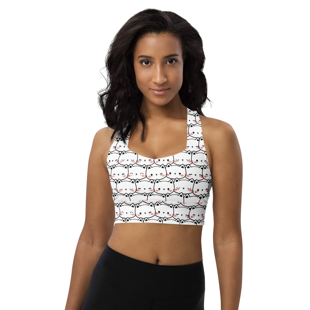 White recycled longline sports bra with black outlined cartoon cats and pink blush cheeks for high intensity support