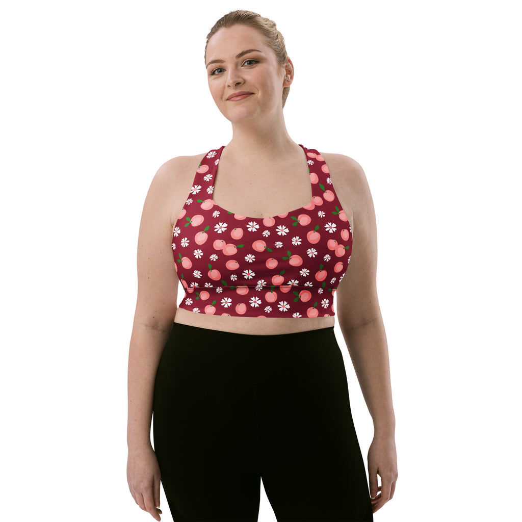 A maroon buttery soft recycled longline sports bra with pink peach and white floral print for high intensity support