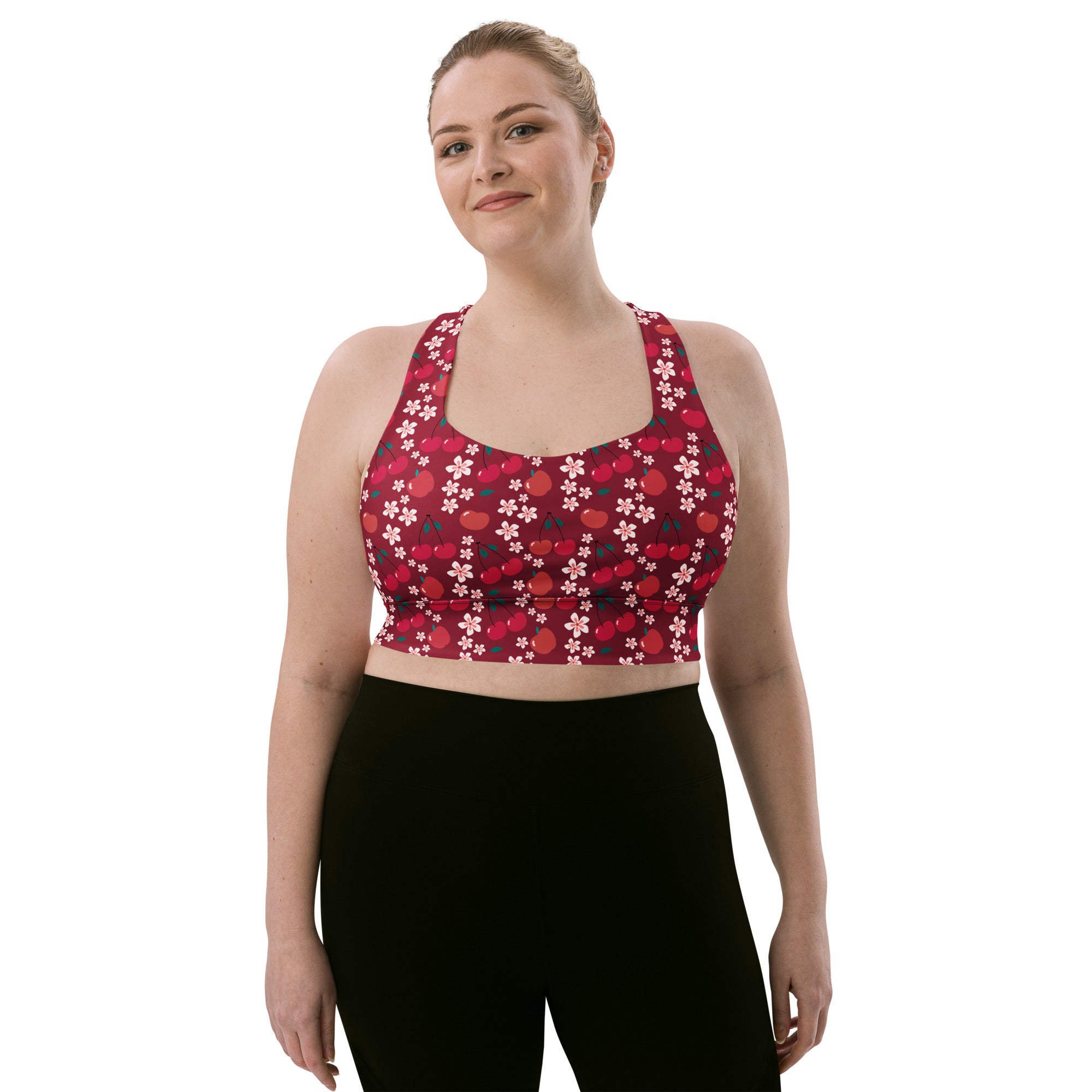 Women’s plus-size longline sports bra in red and white cherry blossom pattern with buttery soft recycled fabric and high support