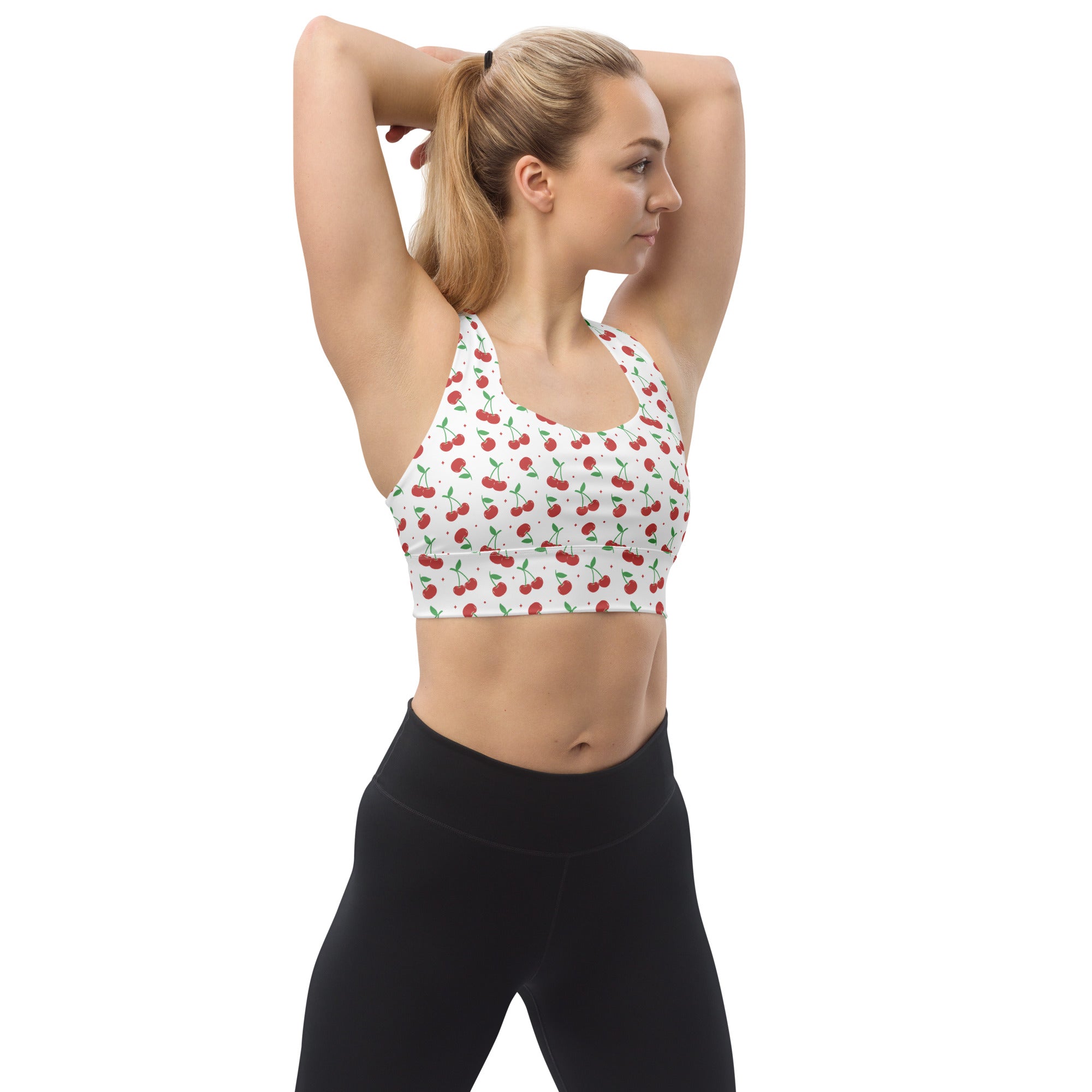 White longline sports bra with red cherry pattern made from buttery soft recycled fabric for high intensity support