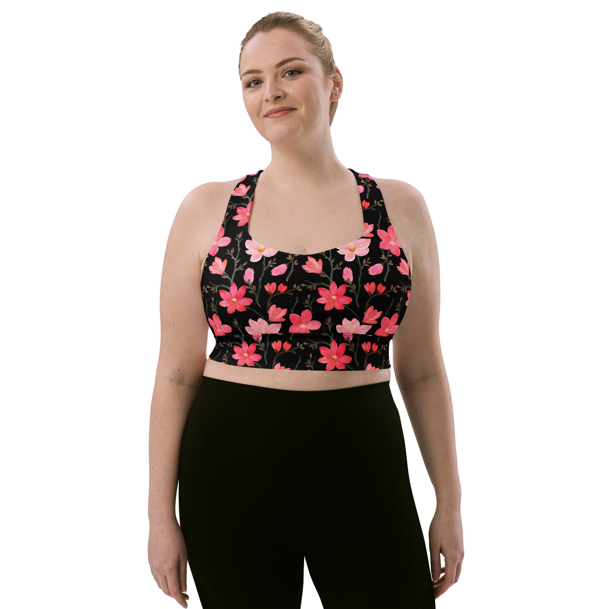 Black longline sports bra with vibrant pink coral floral pattern buttery soft recycled fabric high intensity support