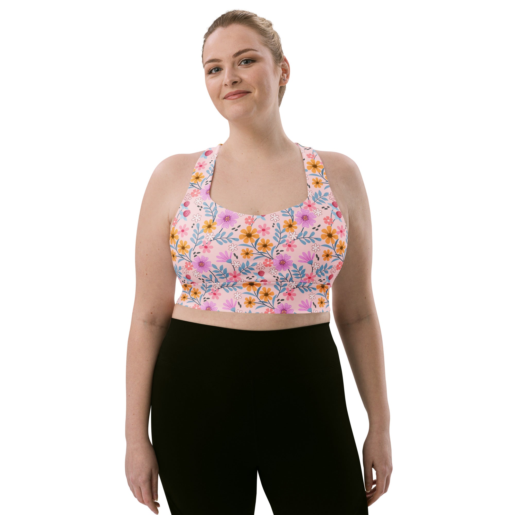 Women’s pink floral buttery soft recycled longline sports bra with yellow purple and blue flowers for high intensity support