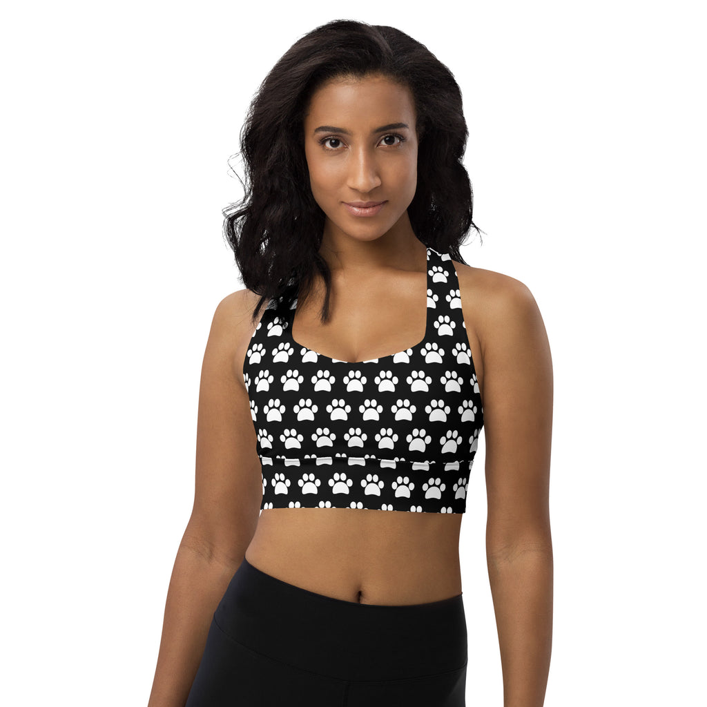Women’s black recycled longline sports bra with white paw print pattern high intensity support and quick dry fabric