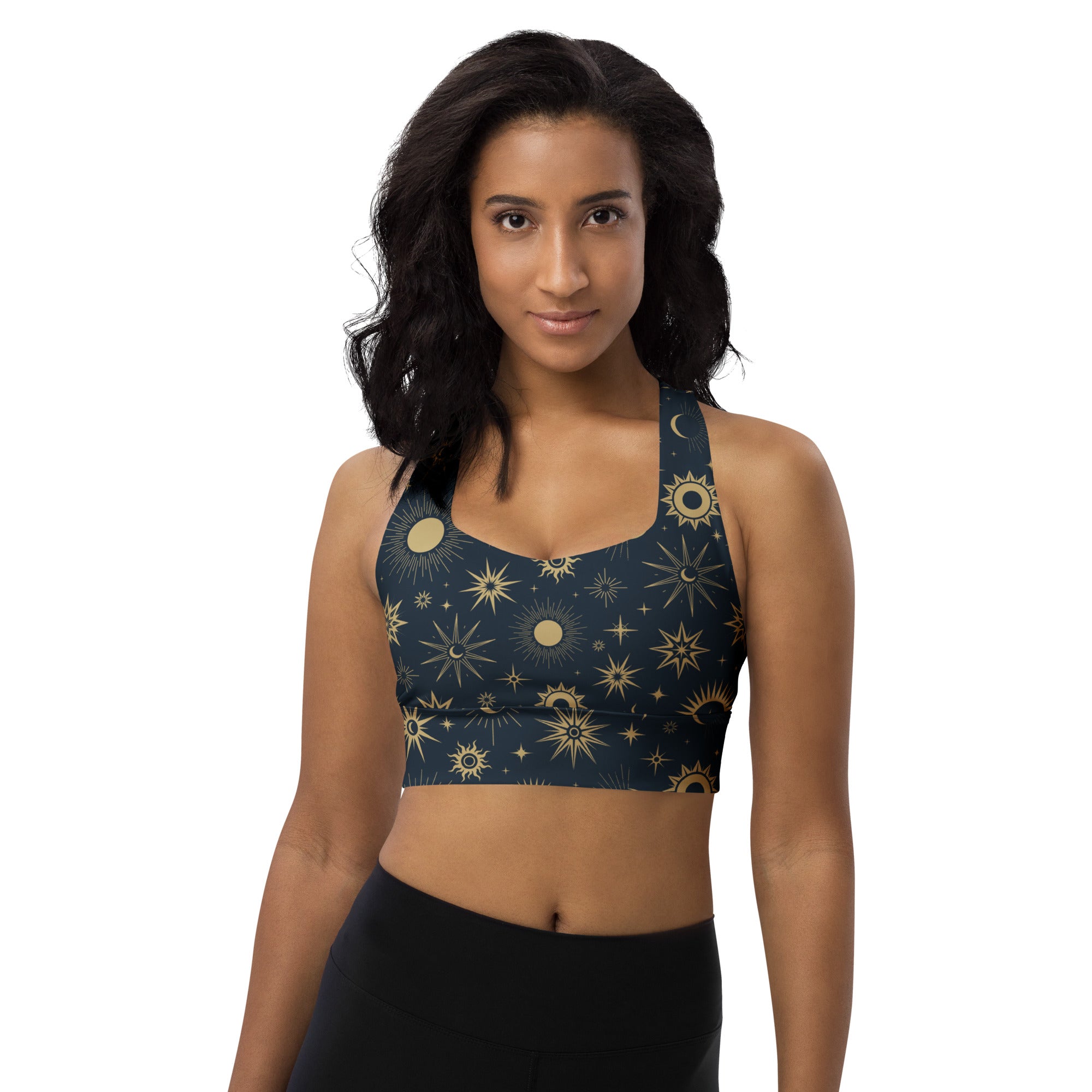 A navy blue longline sports bra with celestial gold suns moons and stars pattern made from buttery soft recycled fabric
