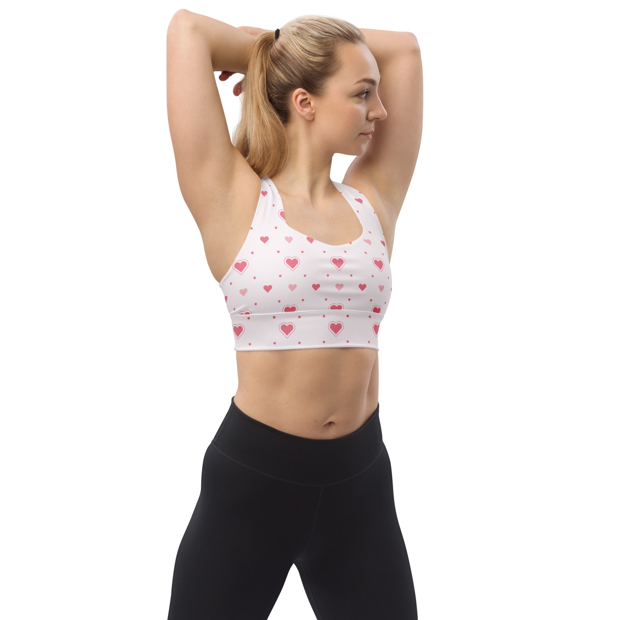 White longline sports bra with pink heart and dot pattern made from buttery soft recycled fabric for high intensity support