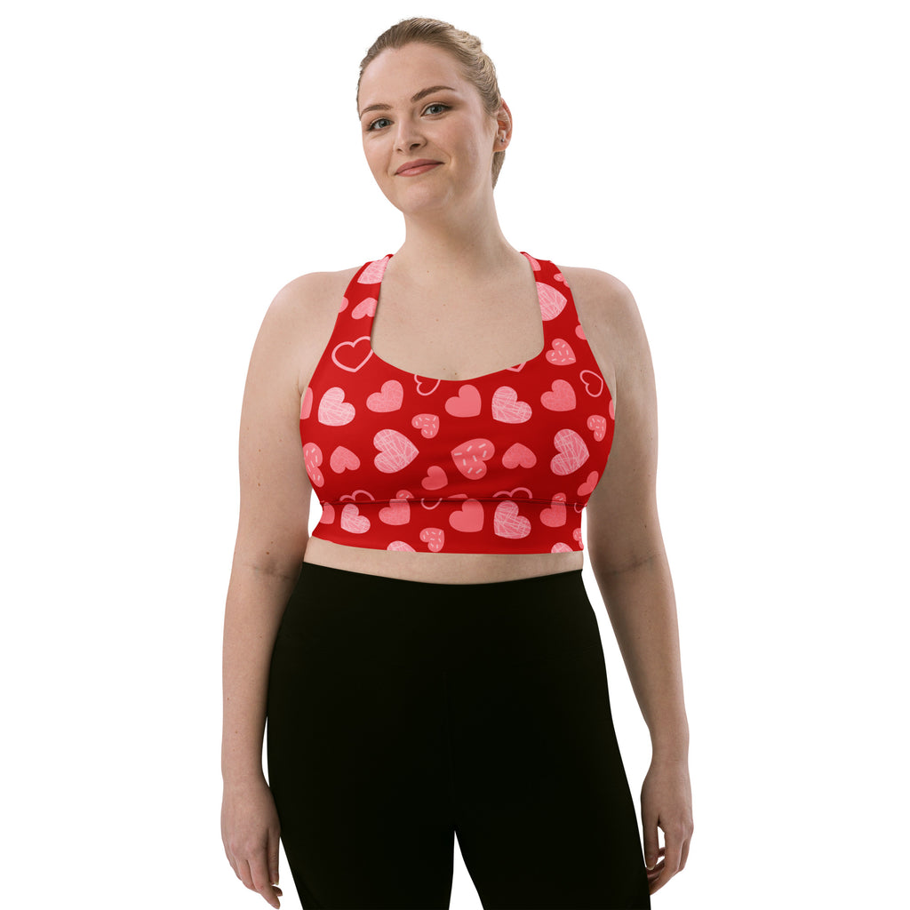 Women’s red heart pattern buttery soft recycled longline sports bra with pink hearts for high intensity support
