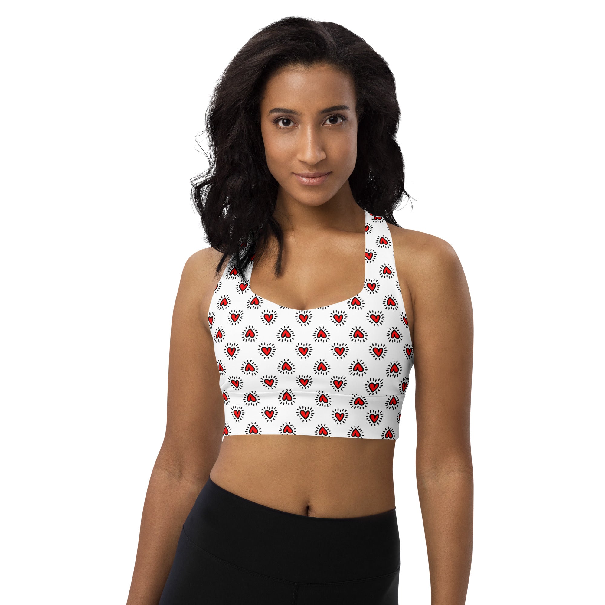 White buttery soft recycled longline sports bra with red heart patterns and halter neck for high intensity support