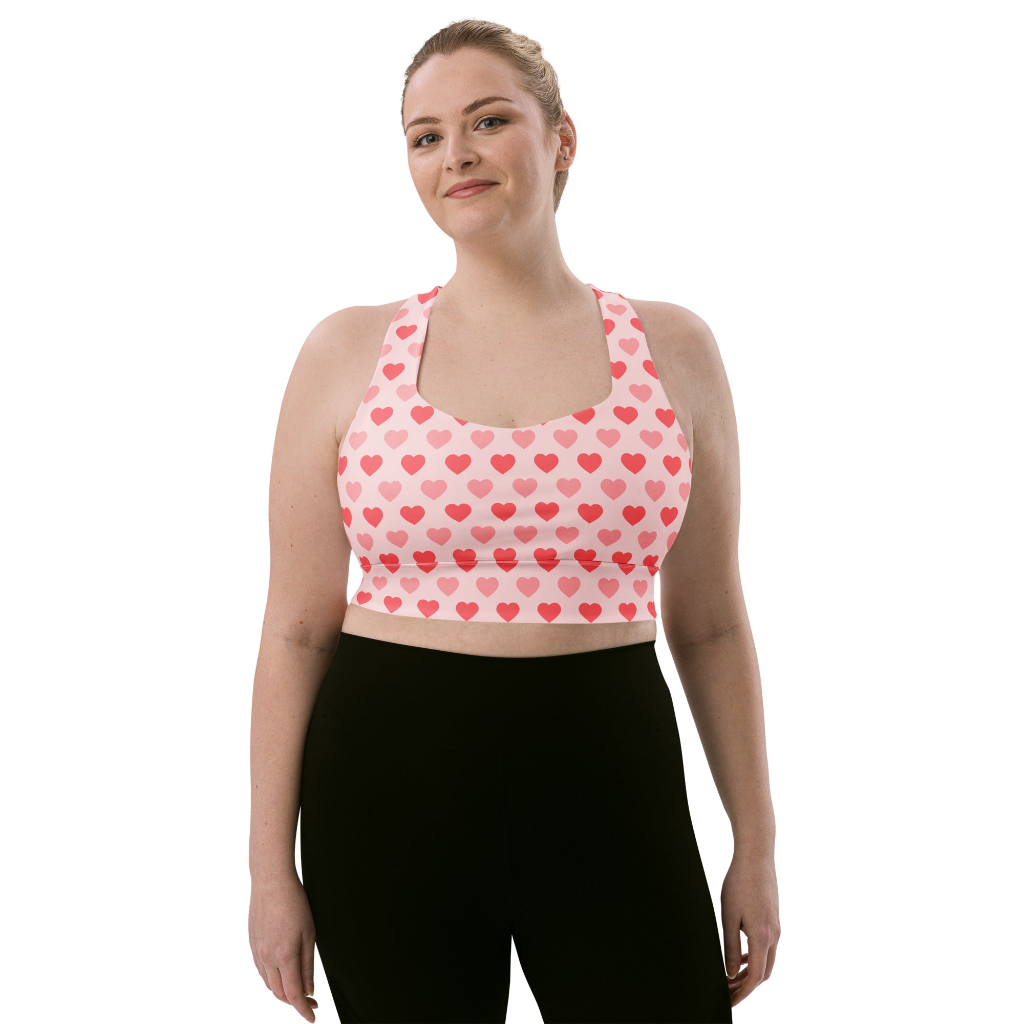 Women’s valentine’s day pink heart pattern recycled sports bra with halter neckline and racerback design for high support