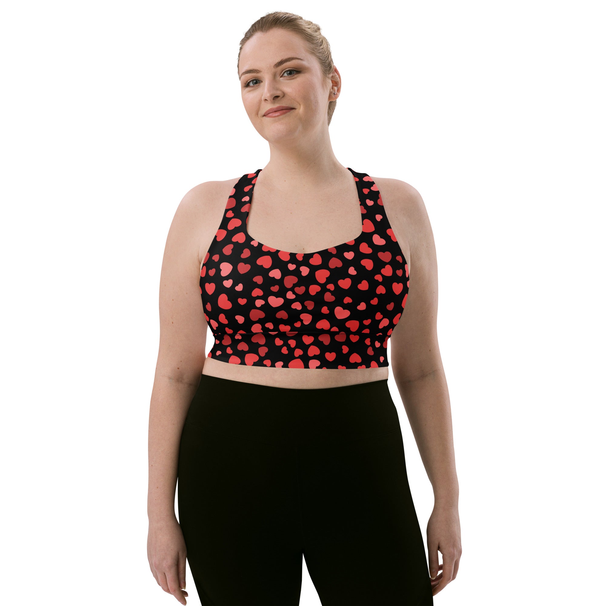 Black buttery soft recycled longline sports bra with red heart pattern designed for high intensity support and quick dry