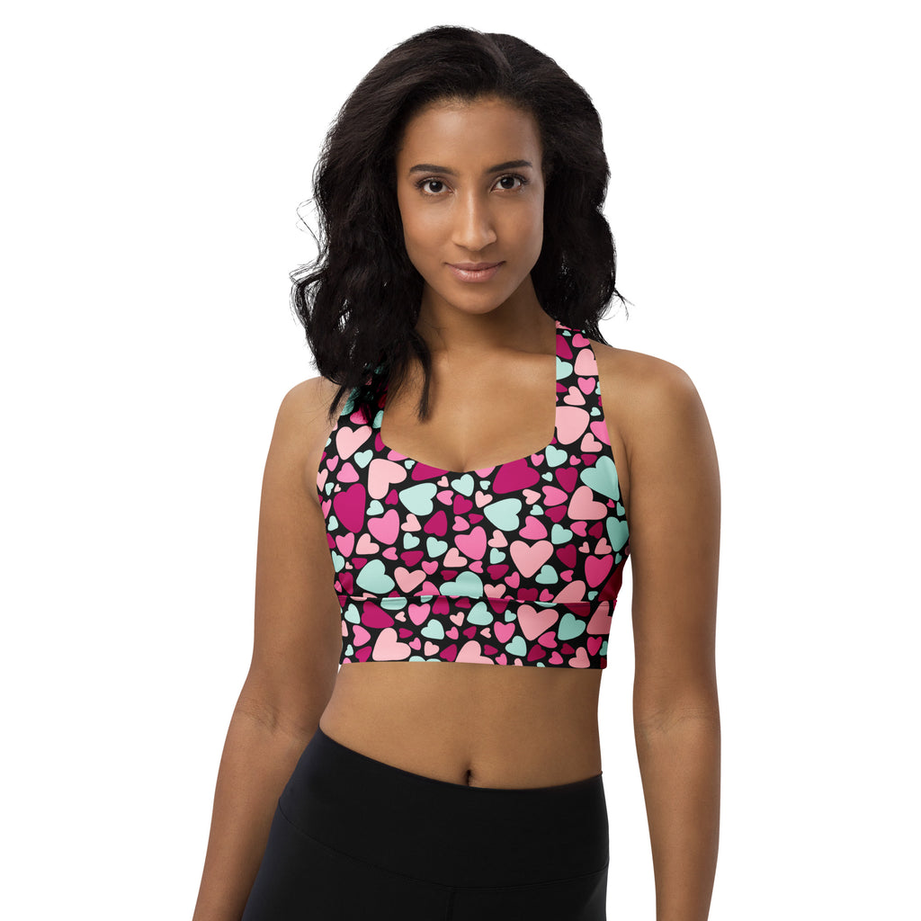 Women’s valentine’s day longline sports bra with vibrant pink magenta and mint heart pattern on black buttery soft fabric