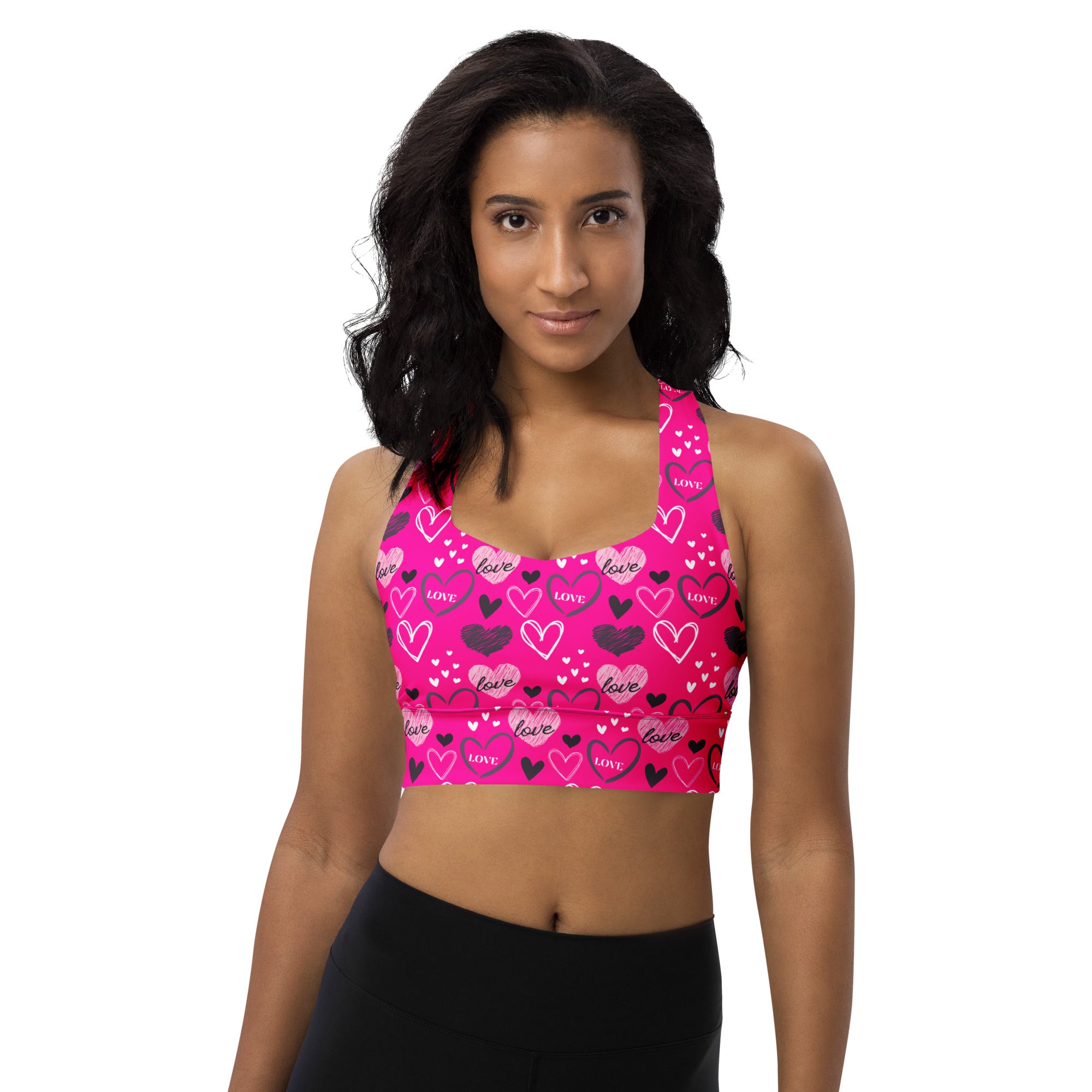 Women’s pink love heart longline sports bra with high intensity support, buttery soft recycled fabric, and quick dry features